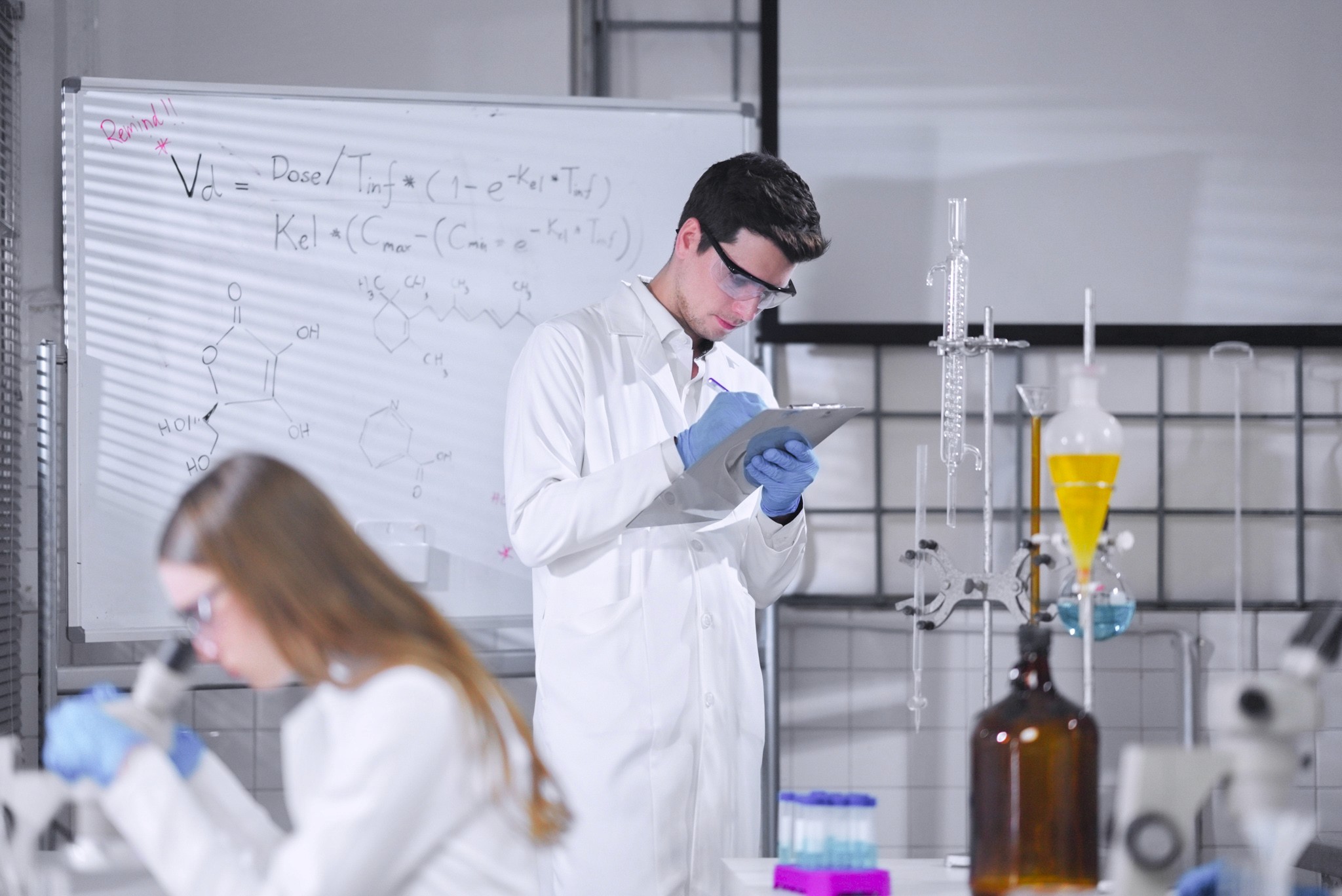 Portrait of a laughing person with curly hair wearing a white shirt