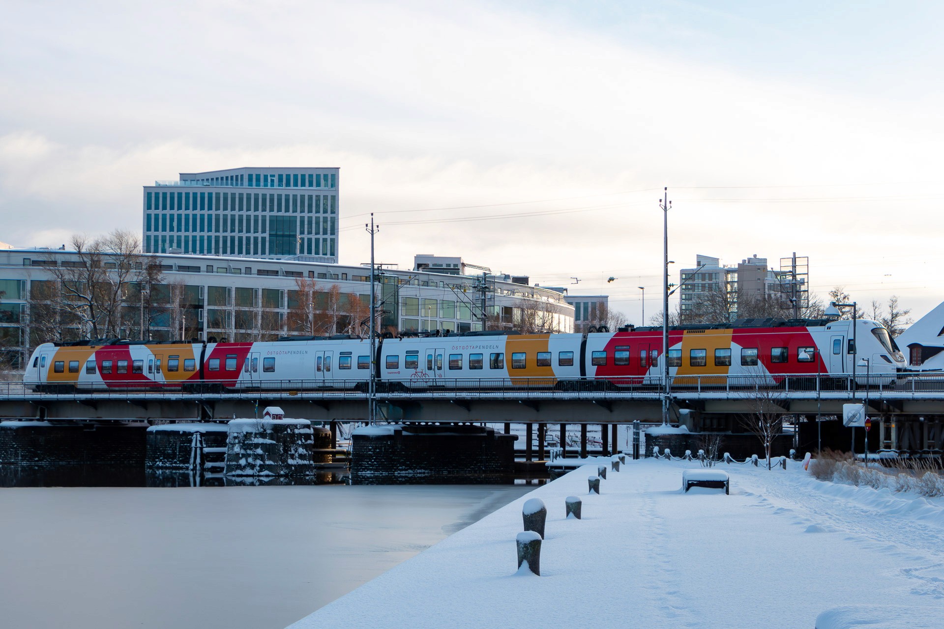 a woman holding a sign in a furniture store