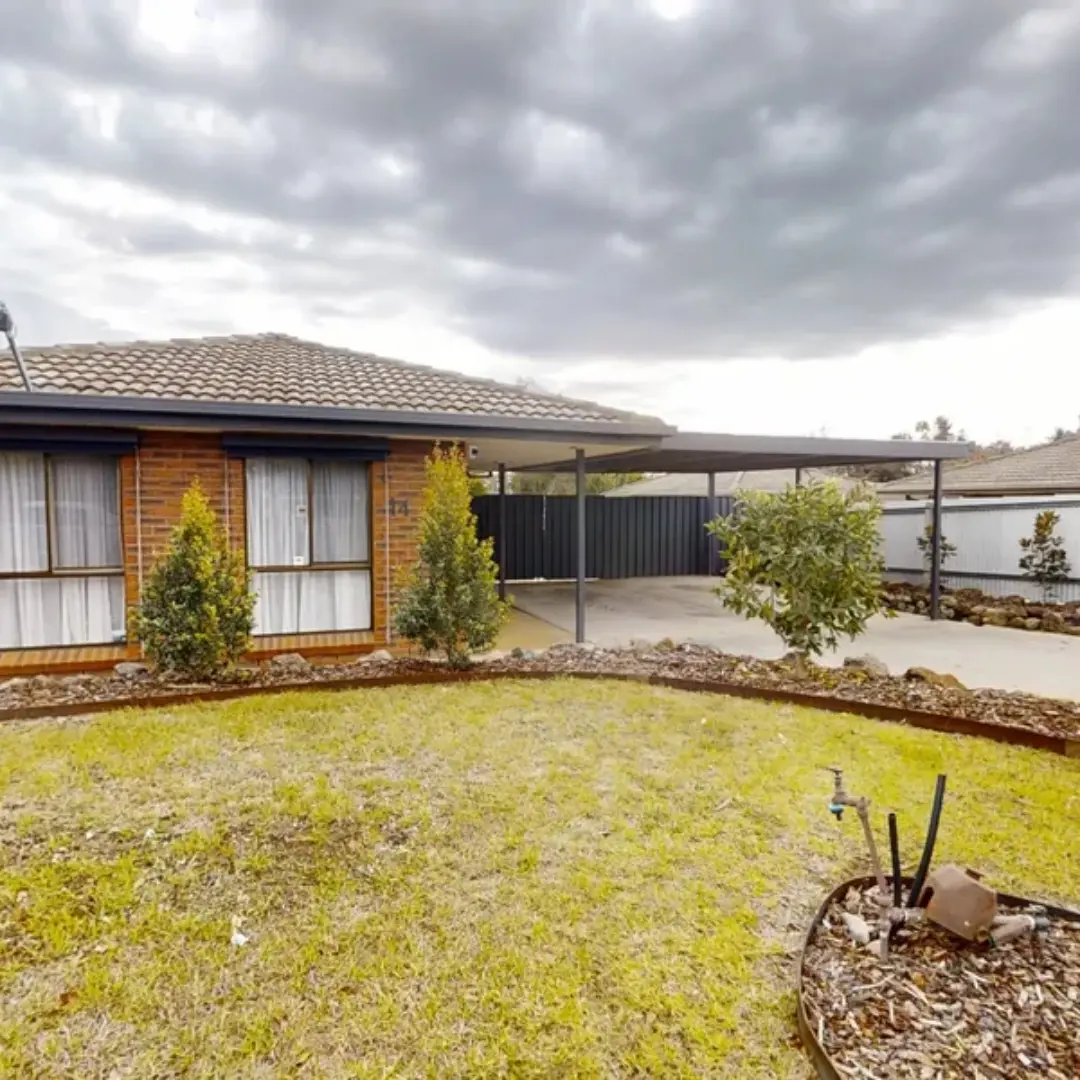 Brick house with carport and yard
