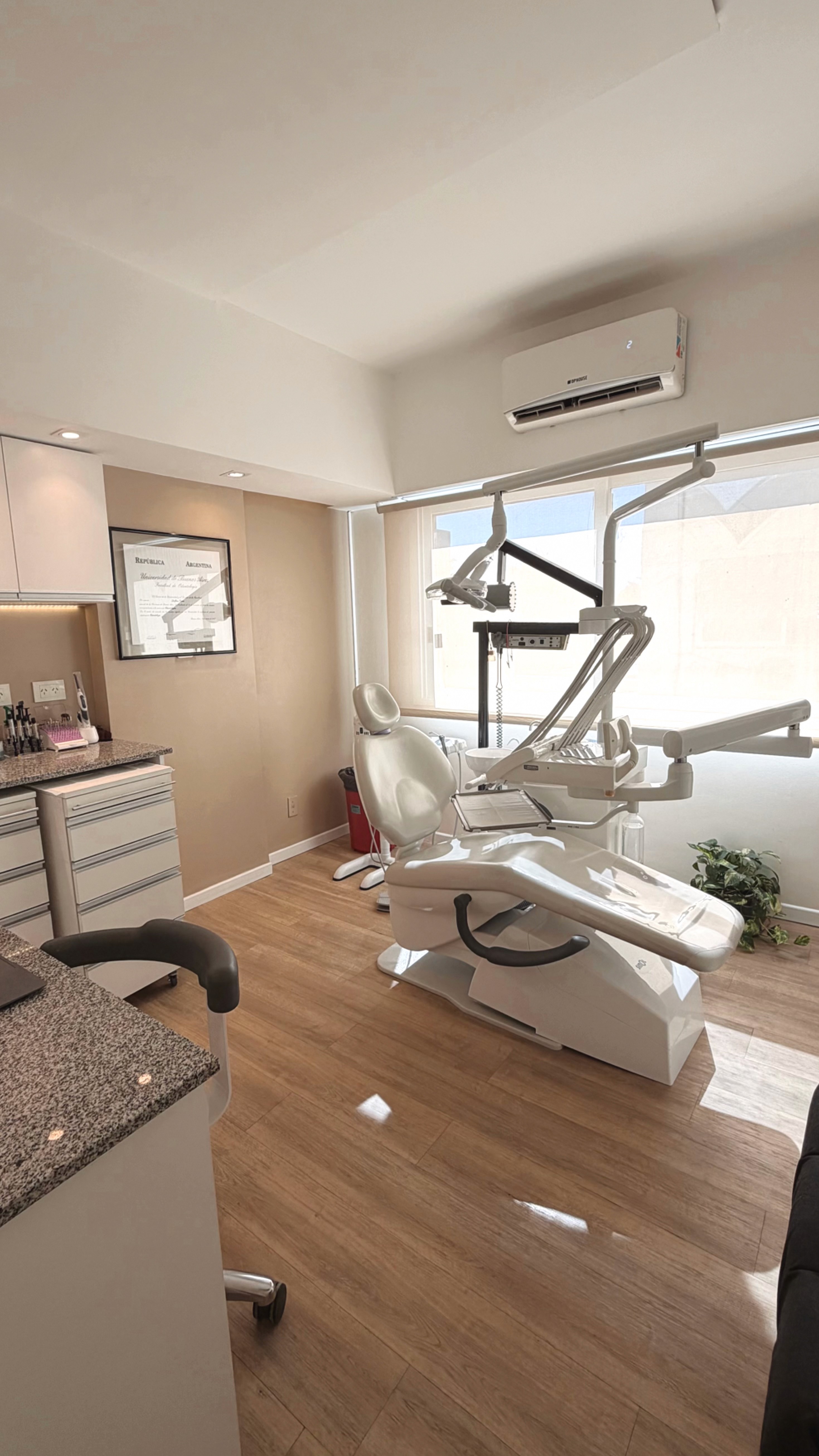 Smiling patient during dental checkup with dentist examining teeth