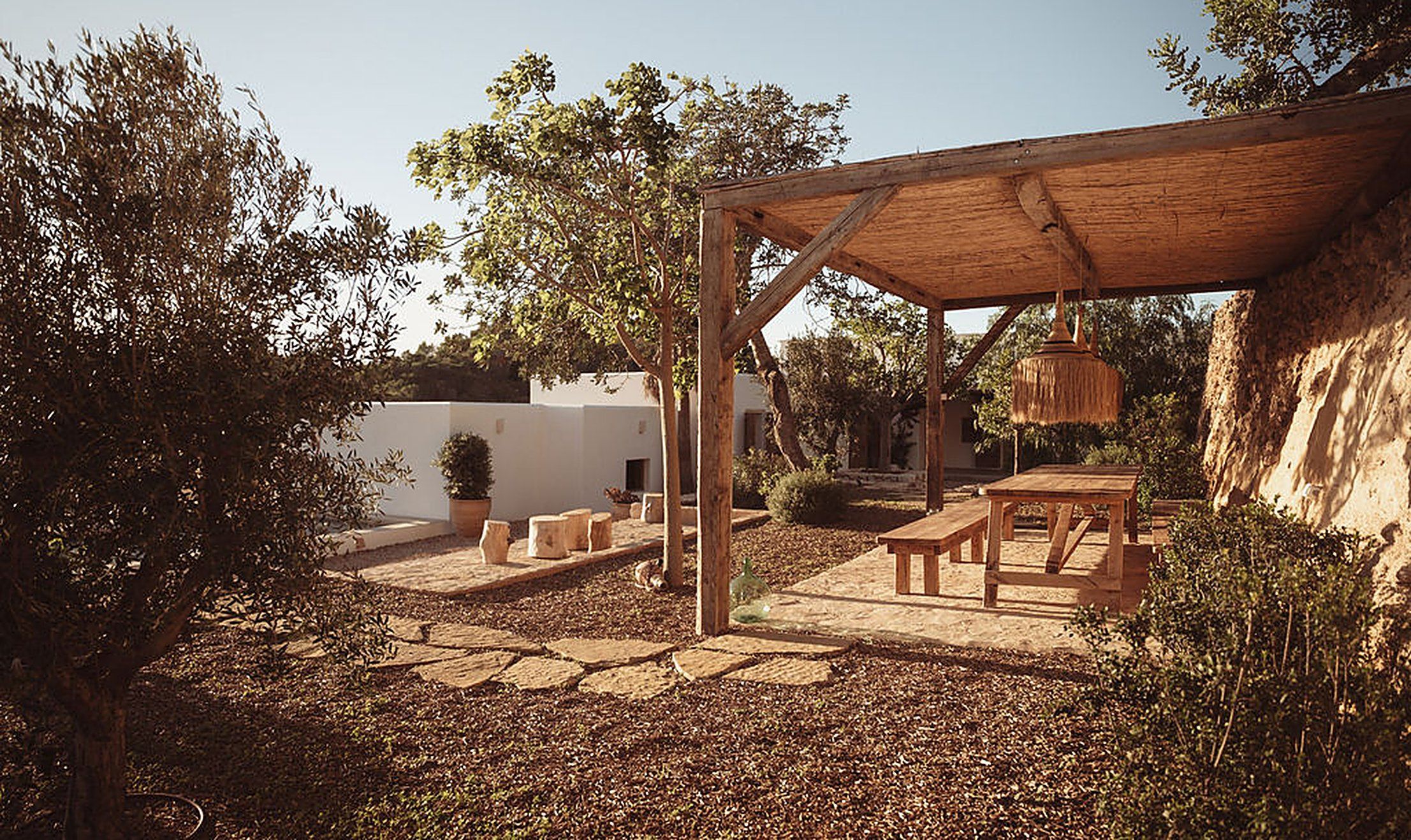 A peaceful terrace by the water with a shaded pergola, a calm space to reconnect with your partner | My Temple
