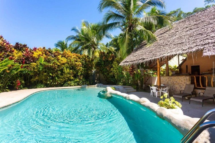 sunloungers fronting buildings near mountain