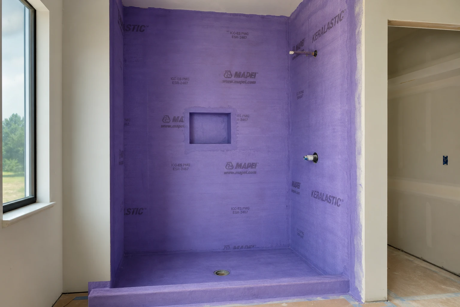 Custom tile shower installation with cement board and waterproofing membrane in a new construction home