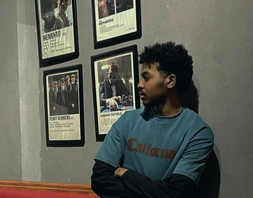 Tree branches reach towards a clear, blue sky.