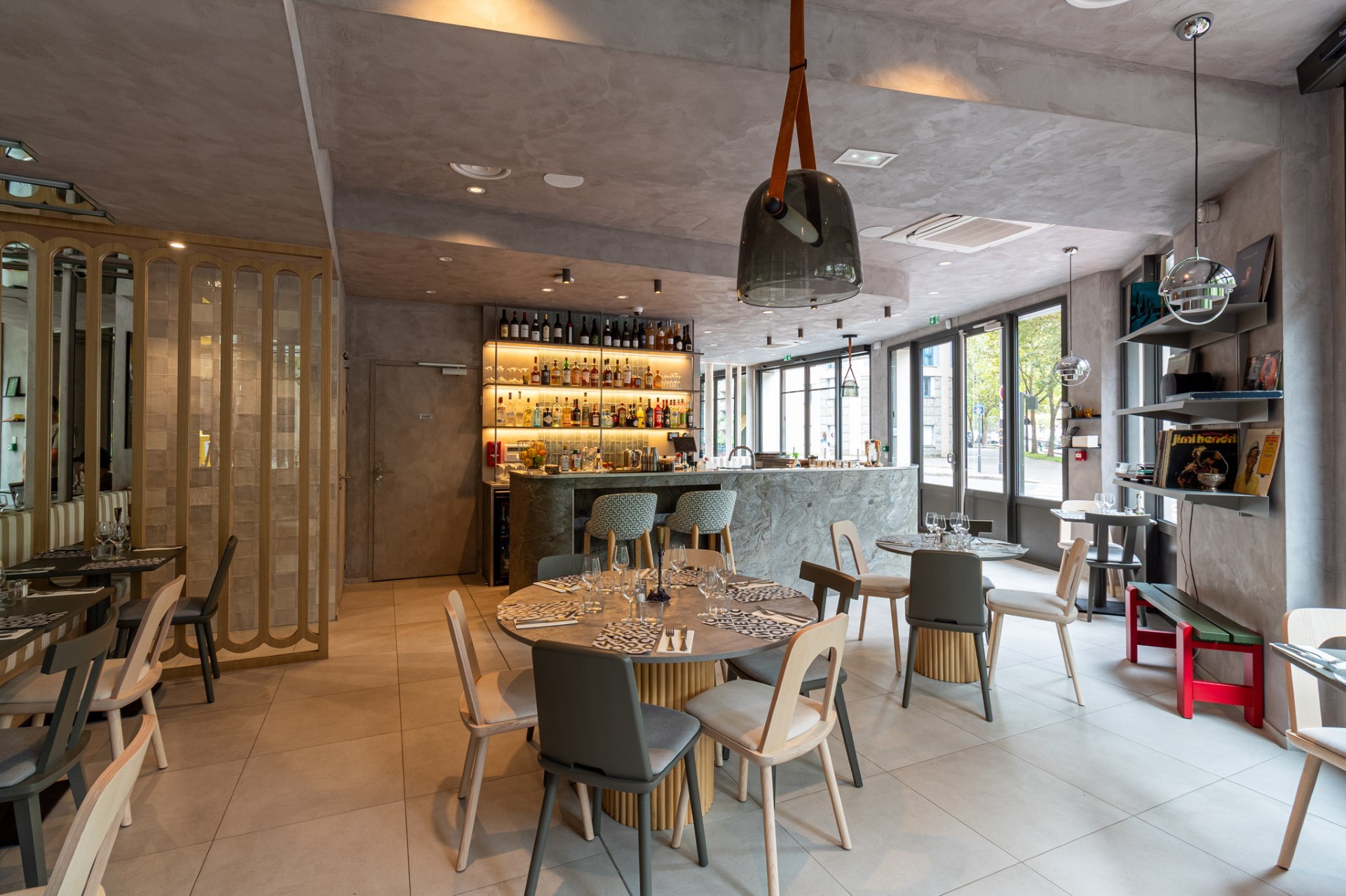 Modern bedroom with plush bed, minimalist art, and sleek lamps. Neutral tones create a serene and inviting atmosphere.