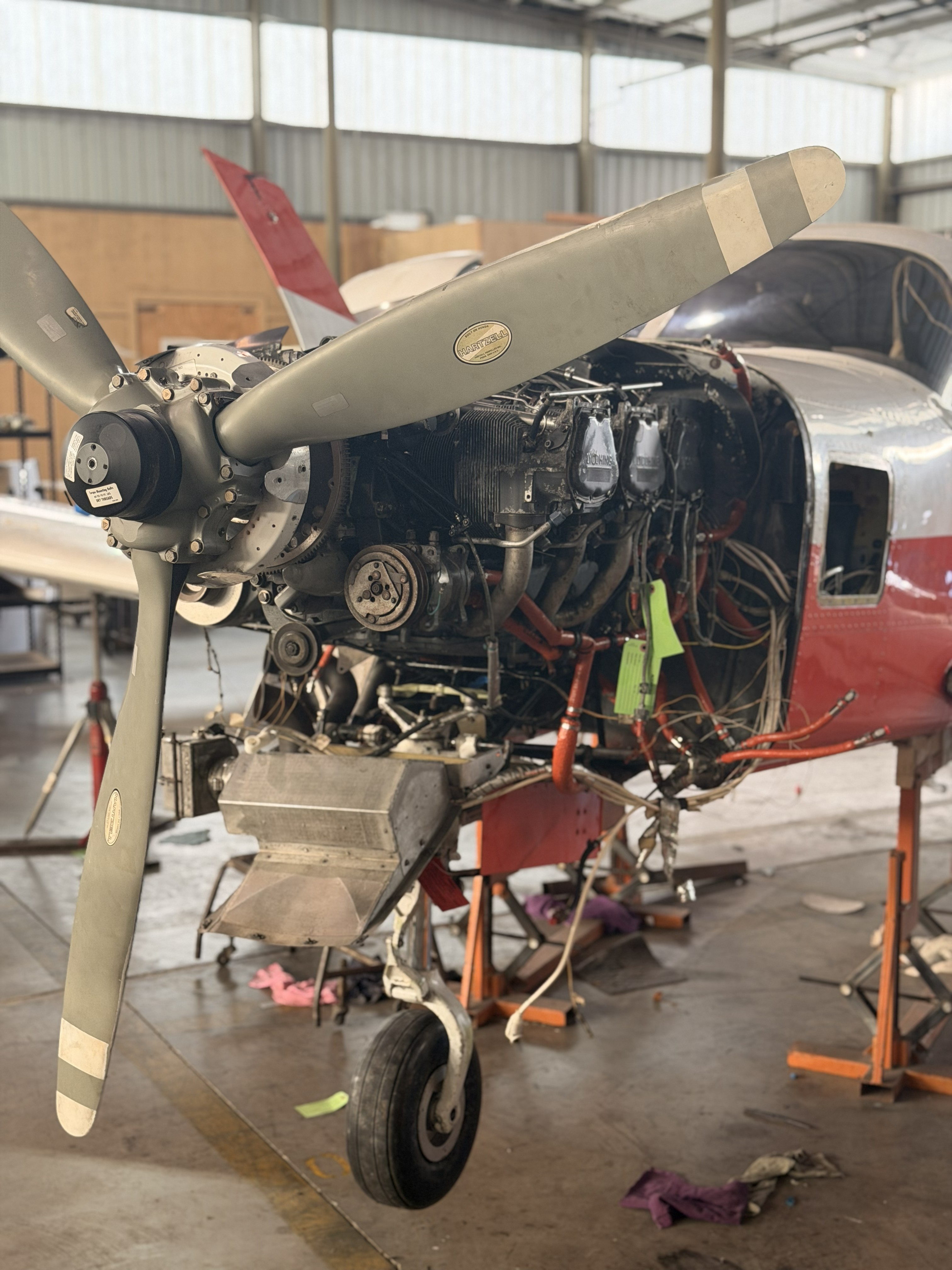 Close-up of wrenches or open end spanners lined up on a wooden board in workshop with selective focus on spanner head and background and foreground blur. Vertical orientation