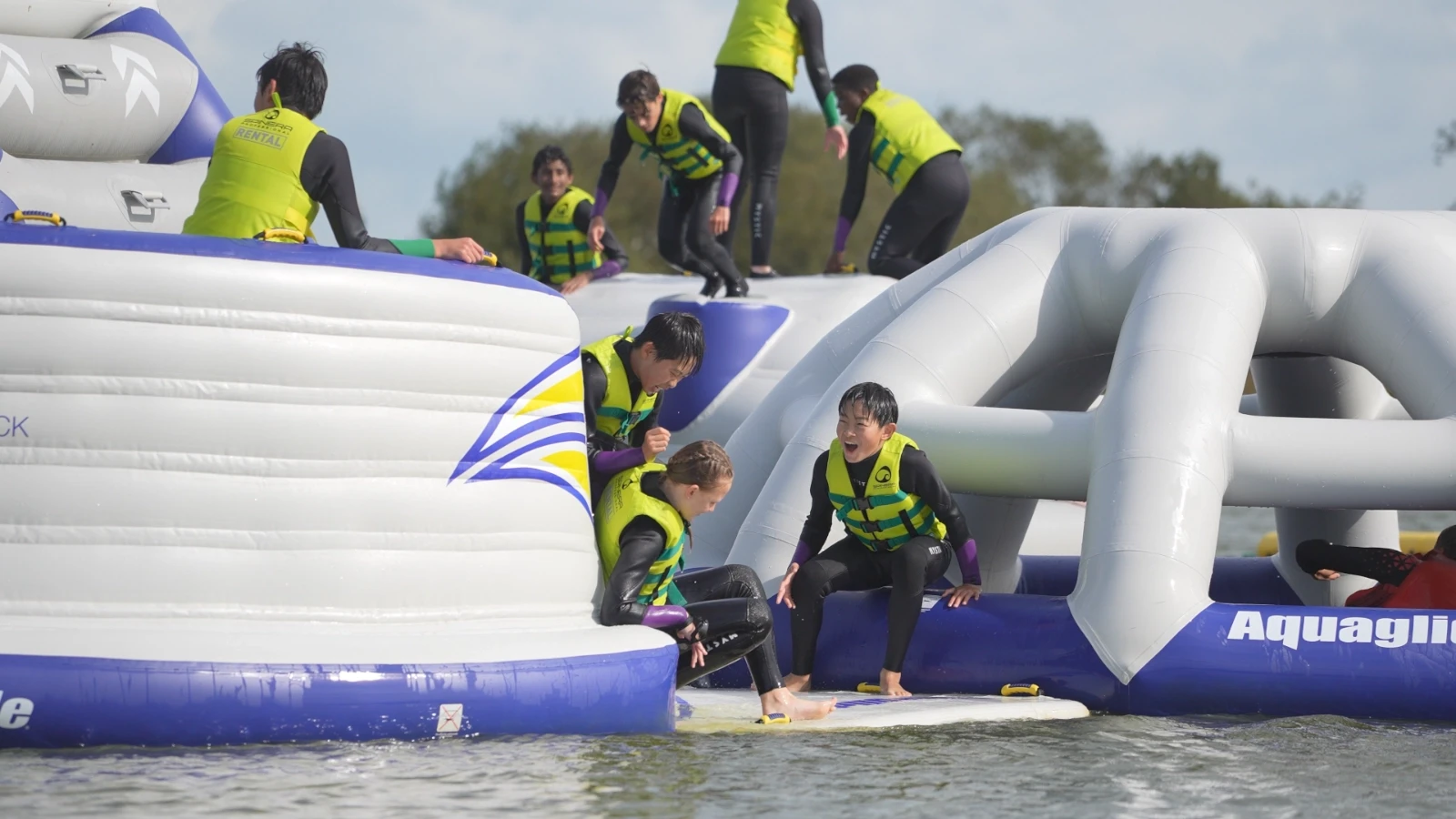 children playing on an inflatable obstscle course