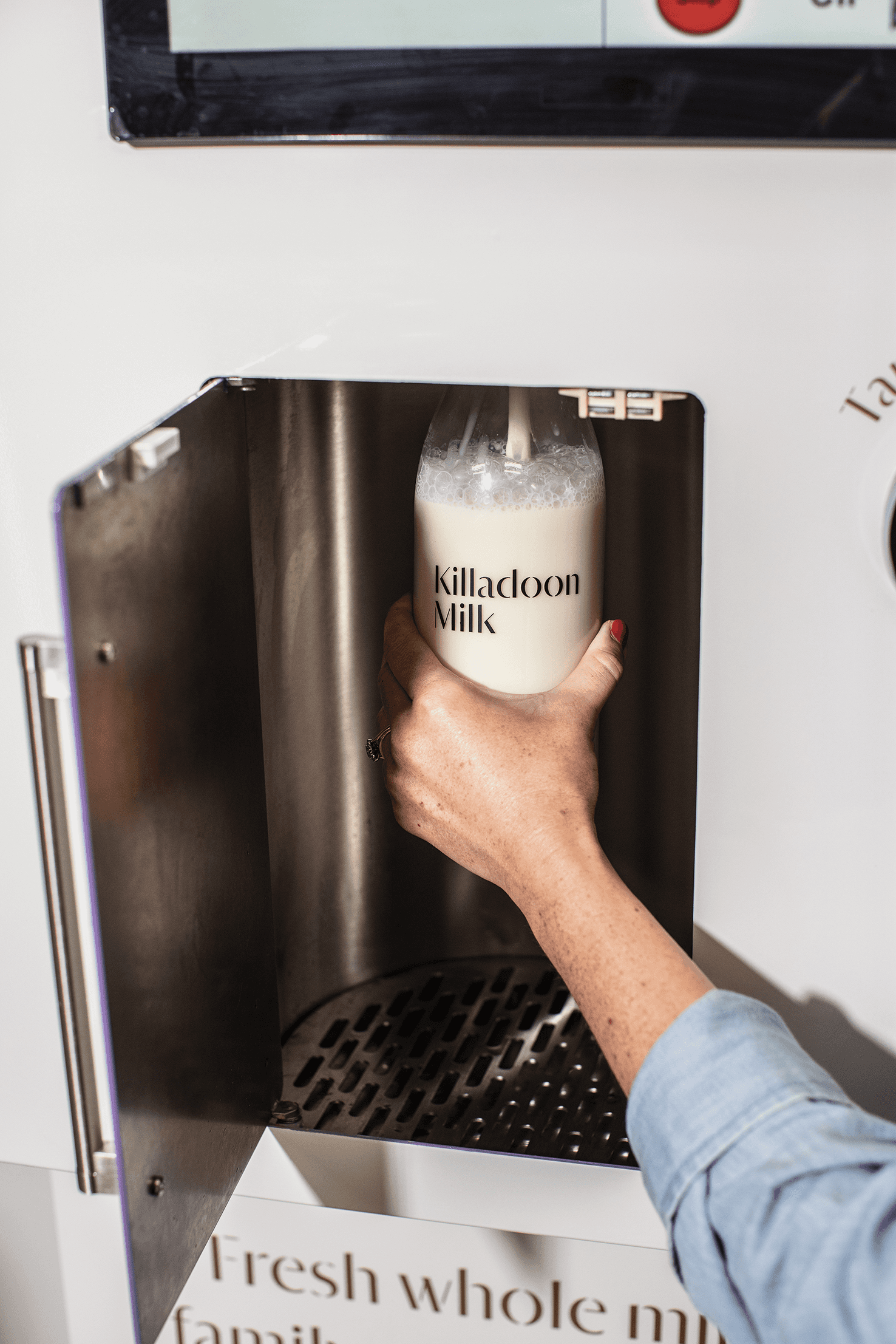 Filling a Killadoon Milk bottle with milk from vending machine