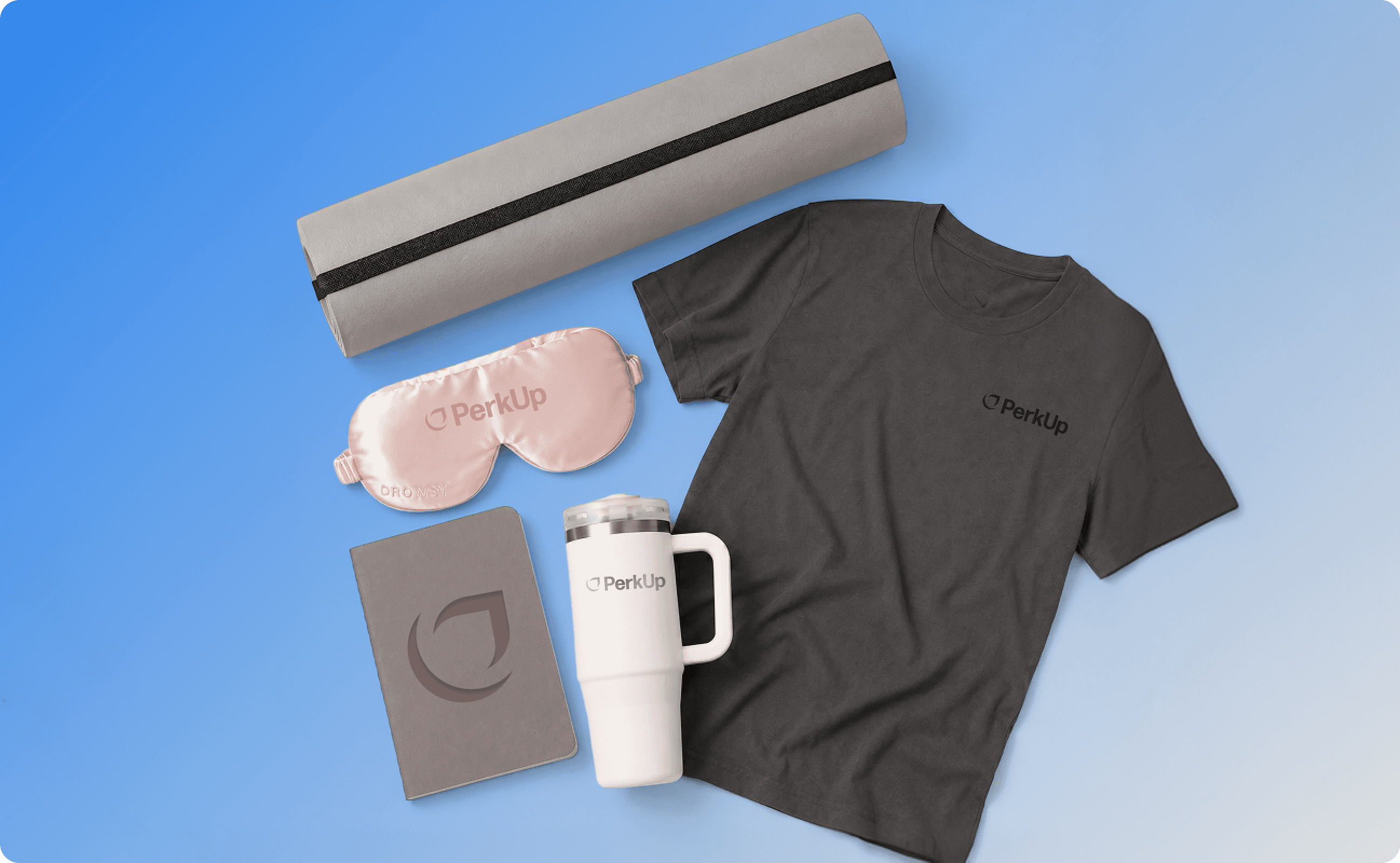 Wellness swag items that include a yoga mat, a sleep mask, a journal, a tumbler, and a t-shirt.