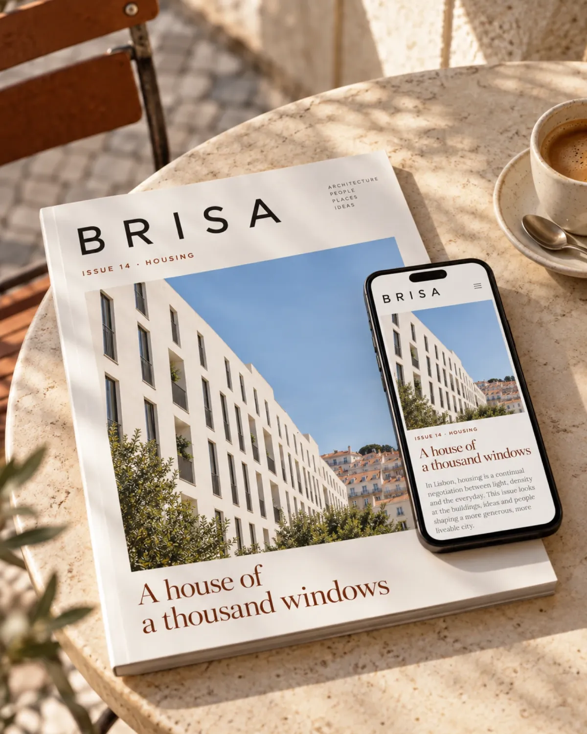 A printed issue of Brisa on a sunny café table, with the same article open on a phone.
