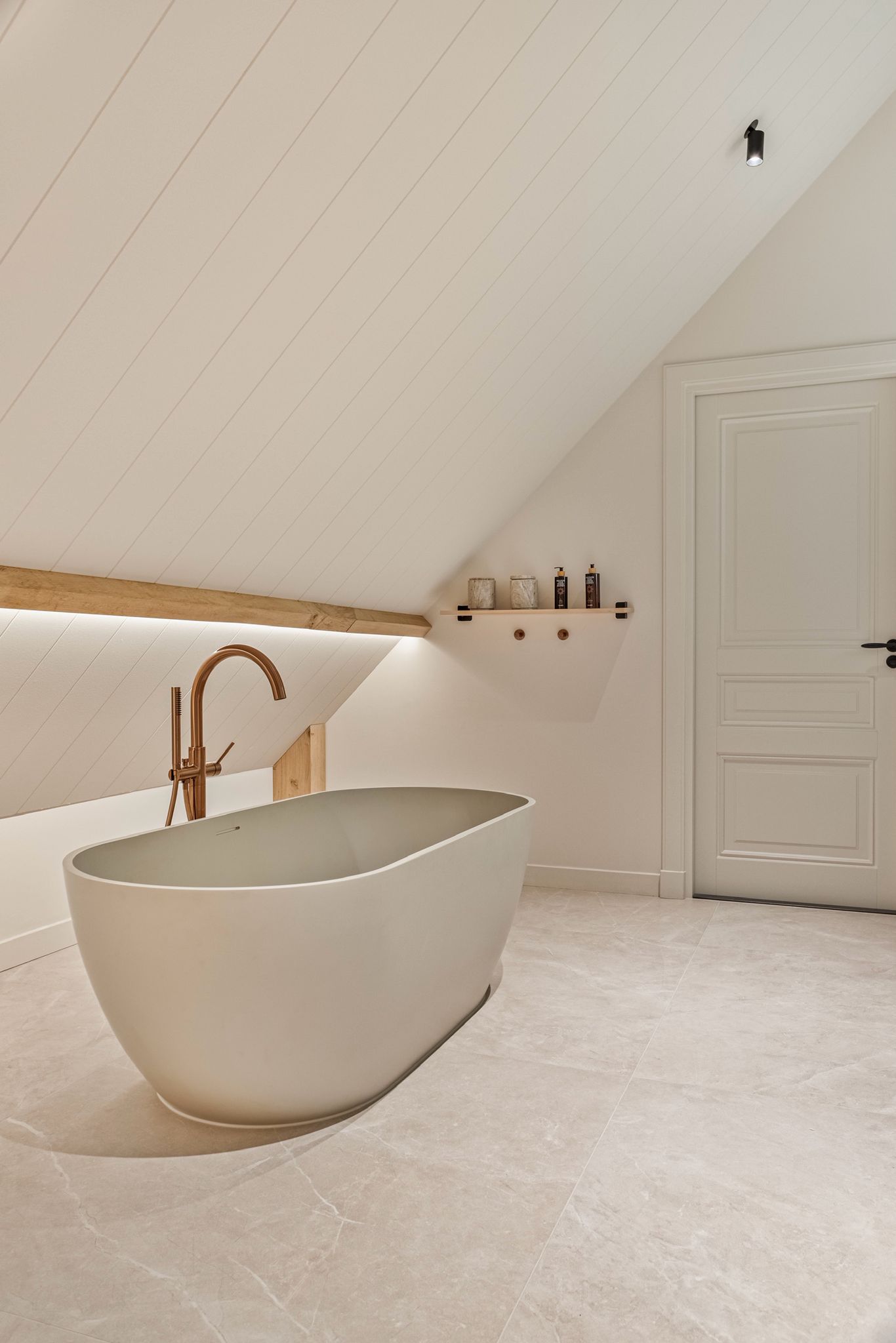 A serene outdoor seating area with two chairs, surrounded by lush greenery and a glassed-in structure.