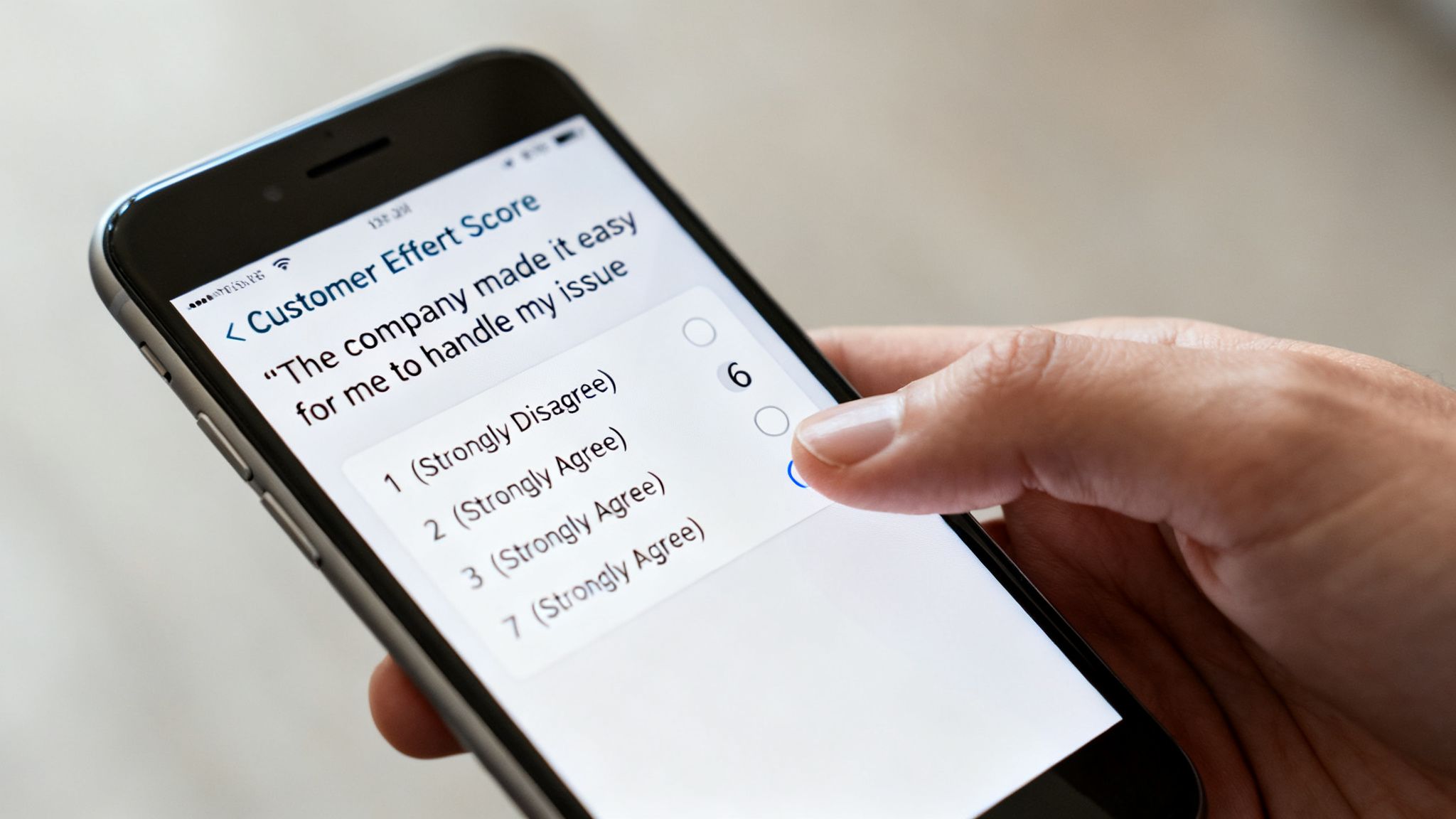 A hand taps '7 Strongly Agree' on a smartphone displaying a Customer Effort Score survey.