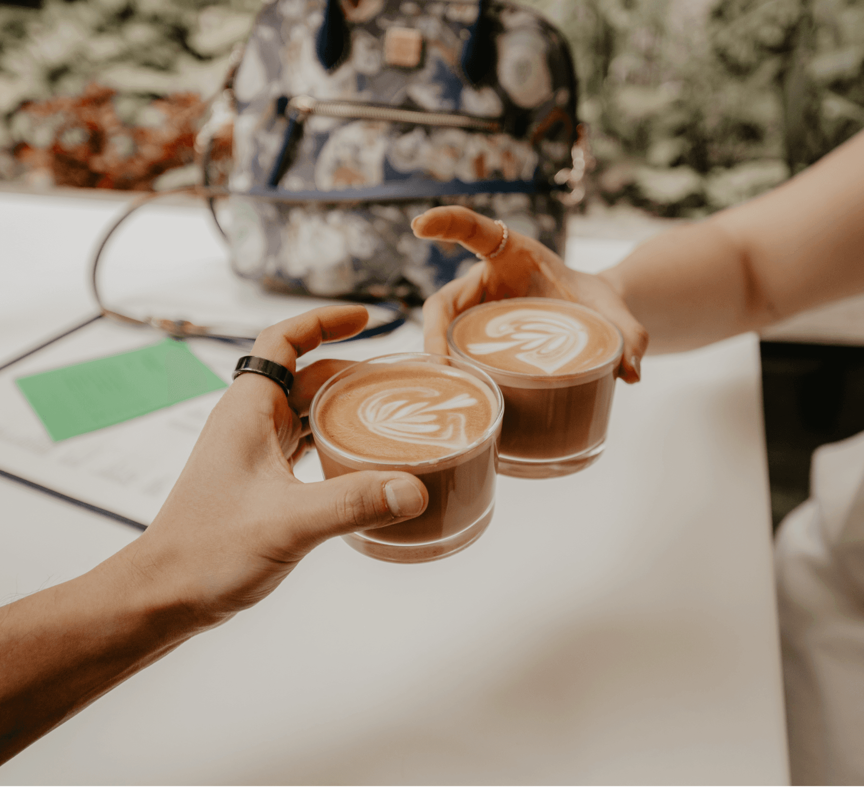 A woman with long blonde hair, in a brown top and jeans, walks through a sunlit forest, holding someone's hand. The scene is warm and inviting.