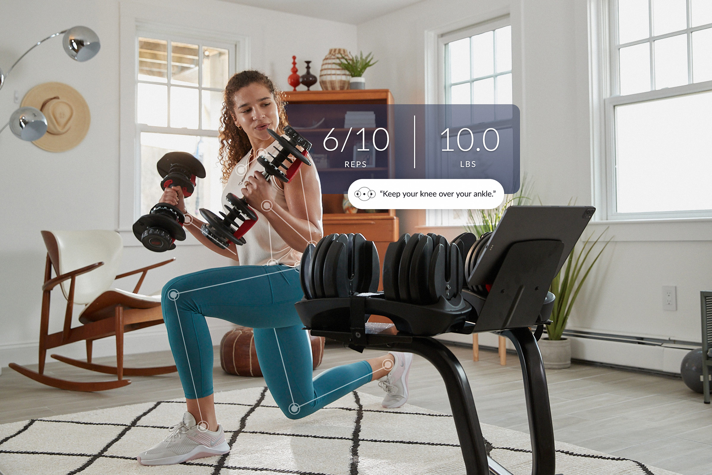 woman doing a strength workout in her living room