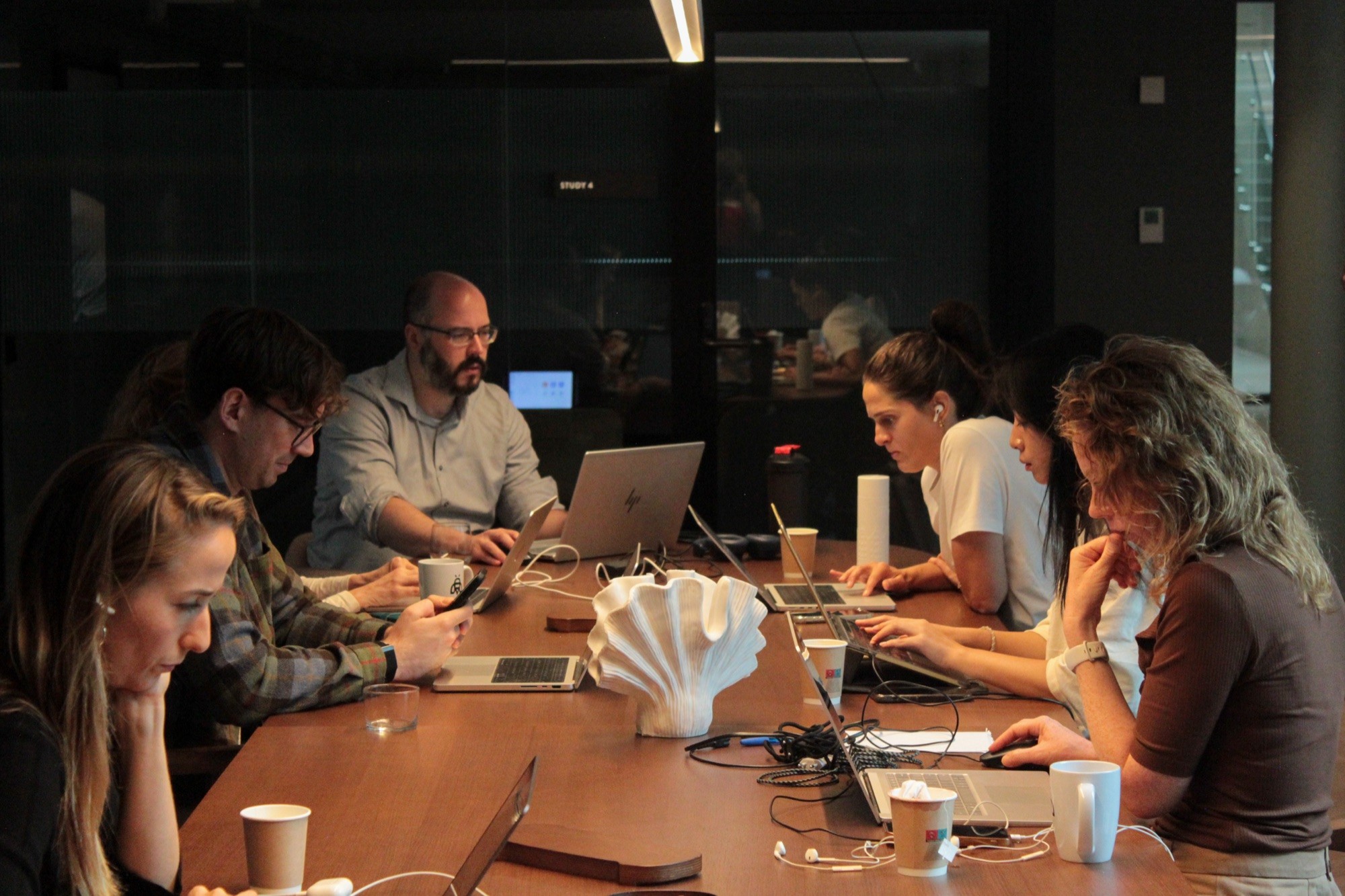 Sollo members working on their outreach together around a table