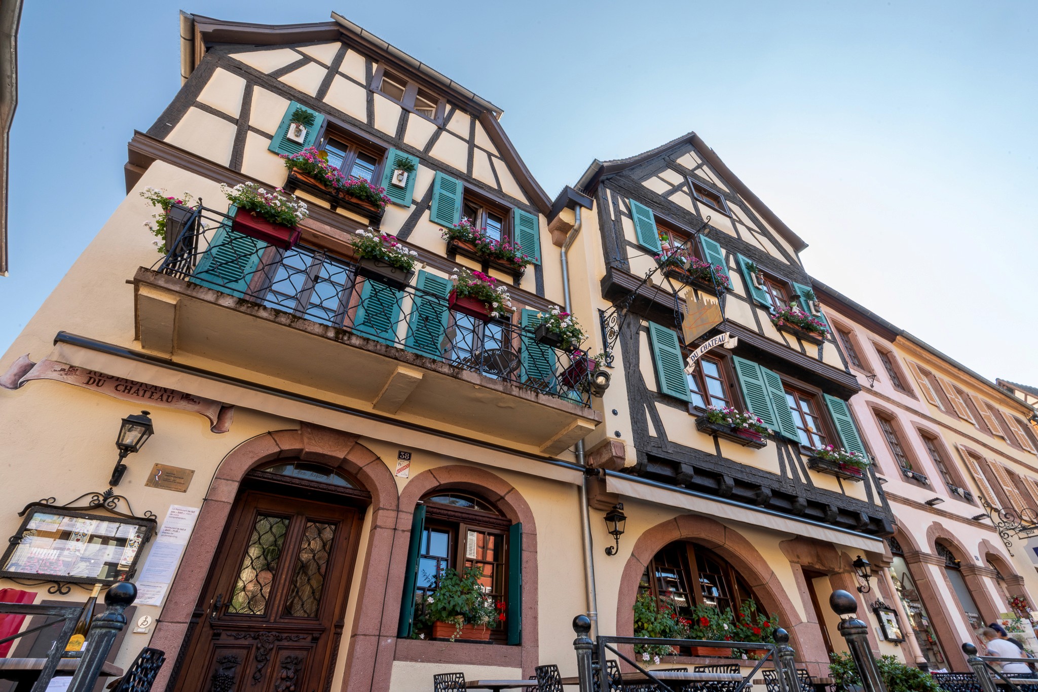 Chef preparing a dish at a rustic wooden table with fresh ingredients.