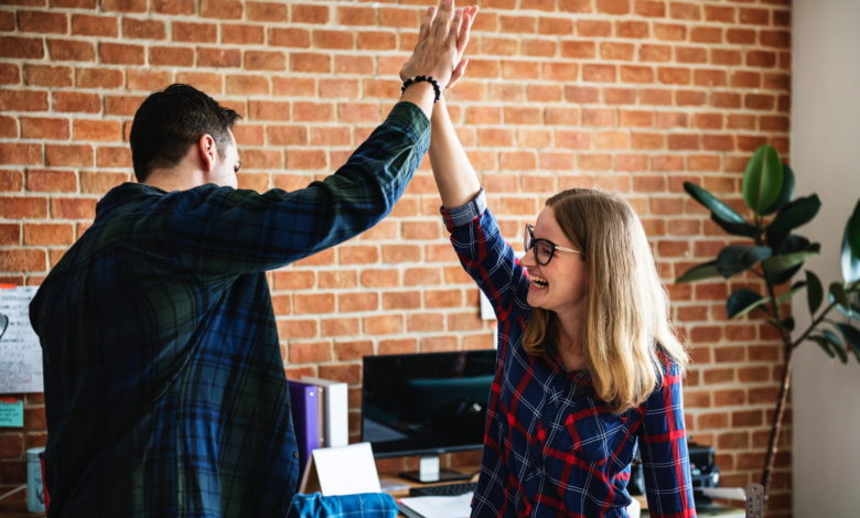 woman giving a high five - Best Sales Acceleration Tools 