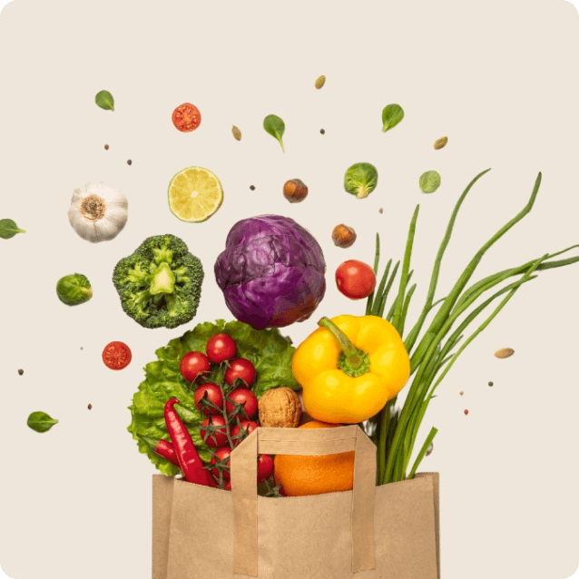 Close-up of a grocery bag filled with fresh ingredients, including vibrant vegetables, fruits, and herbs. The bag is made of paper or reusable material, and the assortment features colorful produce like tomatoes, bell peppers, leafy greens, and citrus fruits, emphasizing a healthy and balanced diet.