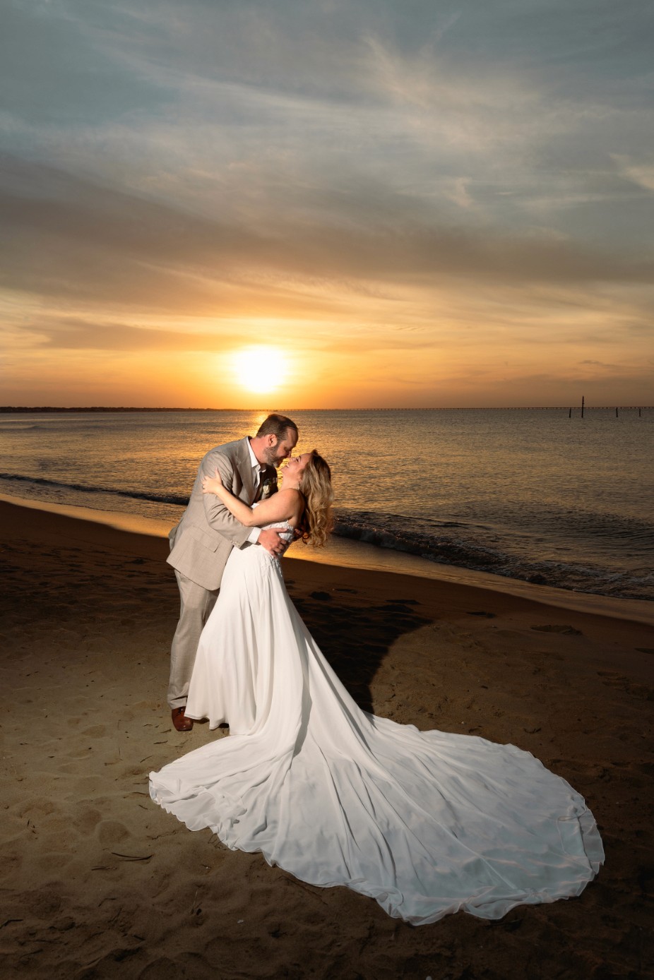 A couple stands closely in an intimate embrace.