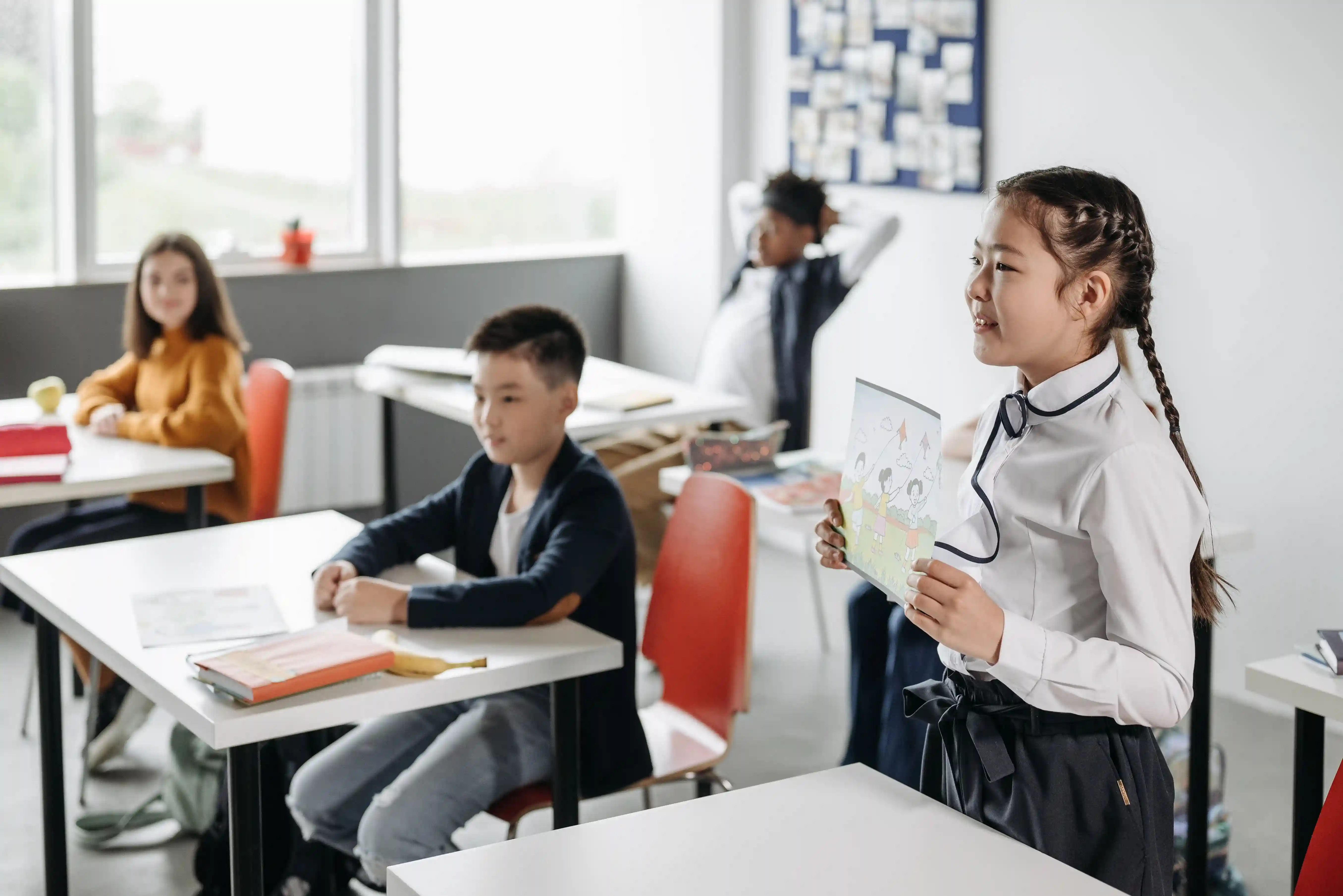 Students actively participating in a classroom at a quality tuition centre in Singapore, demonstrating interactive learning, student engagement, and academic support.