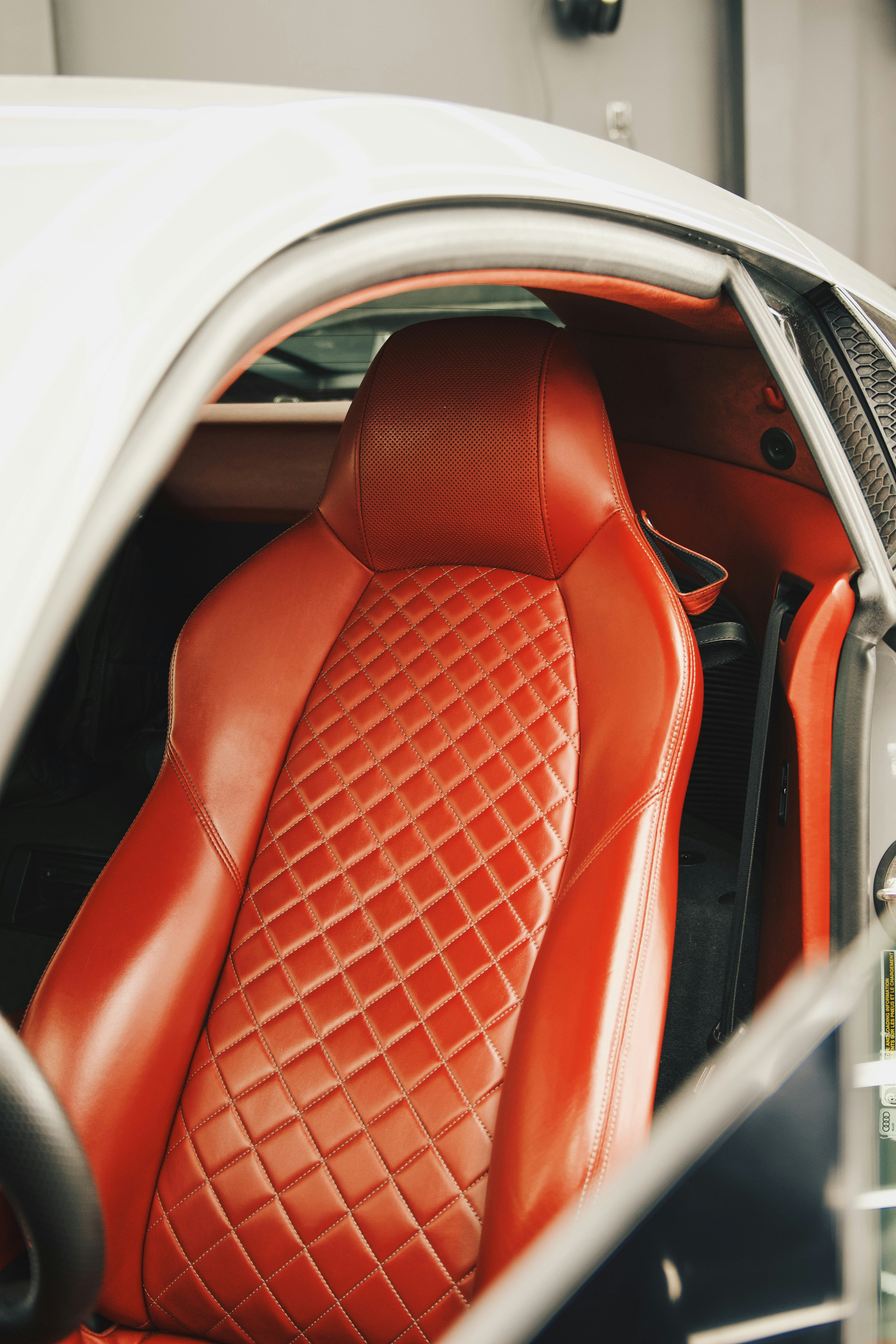 the interior of a car with a red leather seat