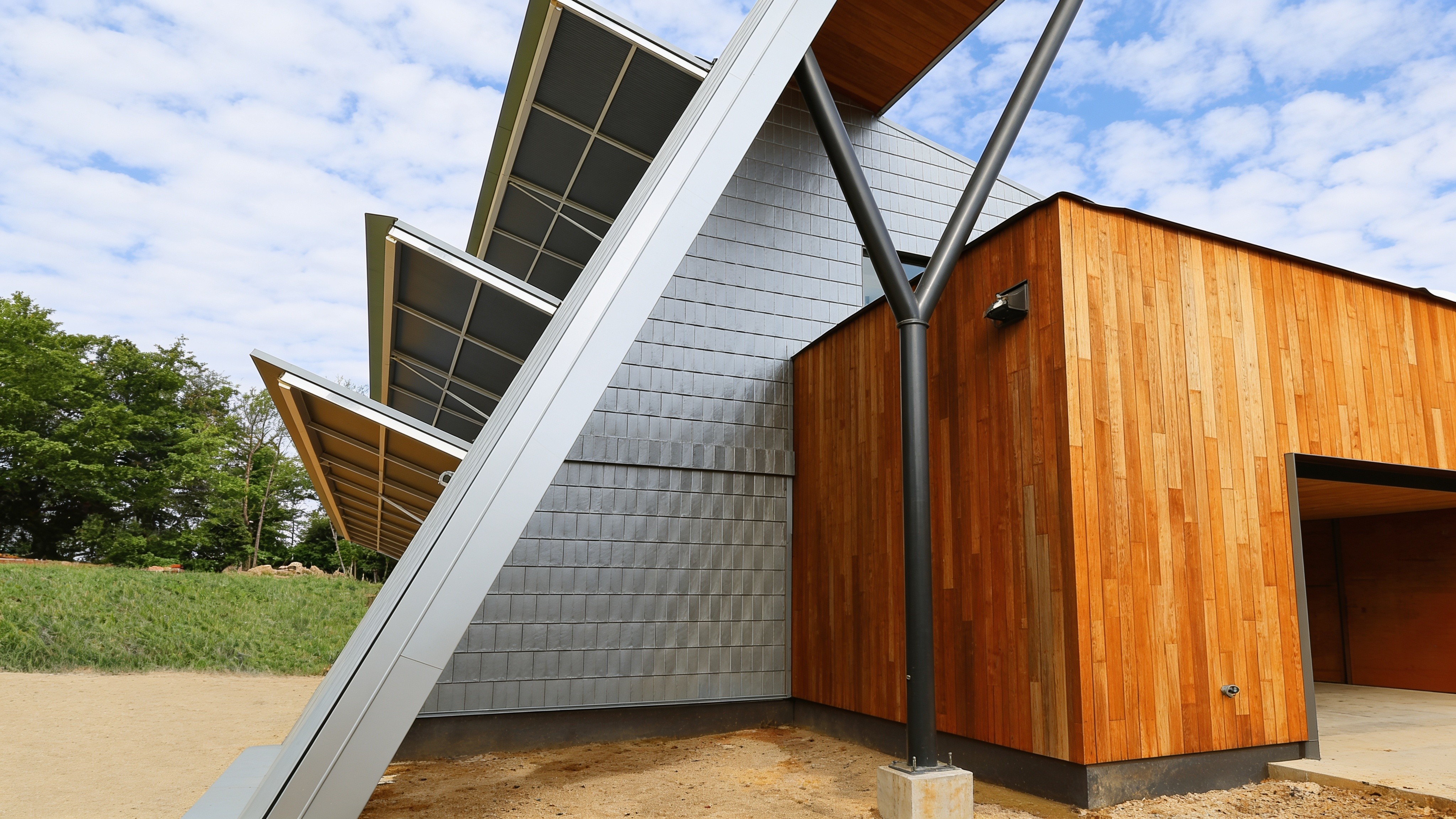 Modern building with angled steel and wood PowerLift shade panels