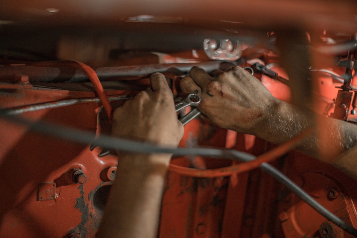Hands working on vehicle wiring during install