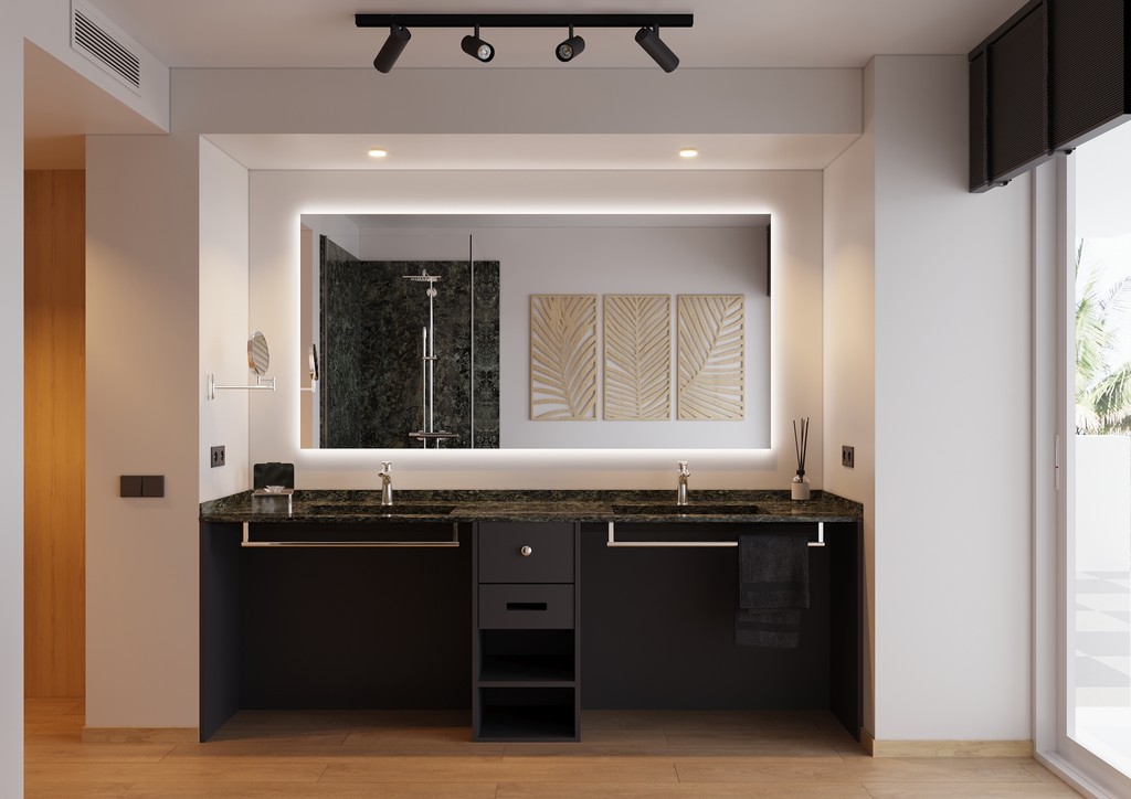 A modern bathroom interior with a double vanity, sleek black cabinets, a large illuminated mirror, and minimalist decor in a contemporary real estate development.