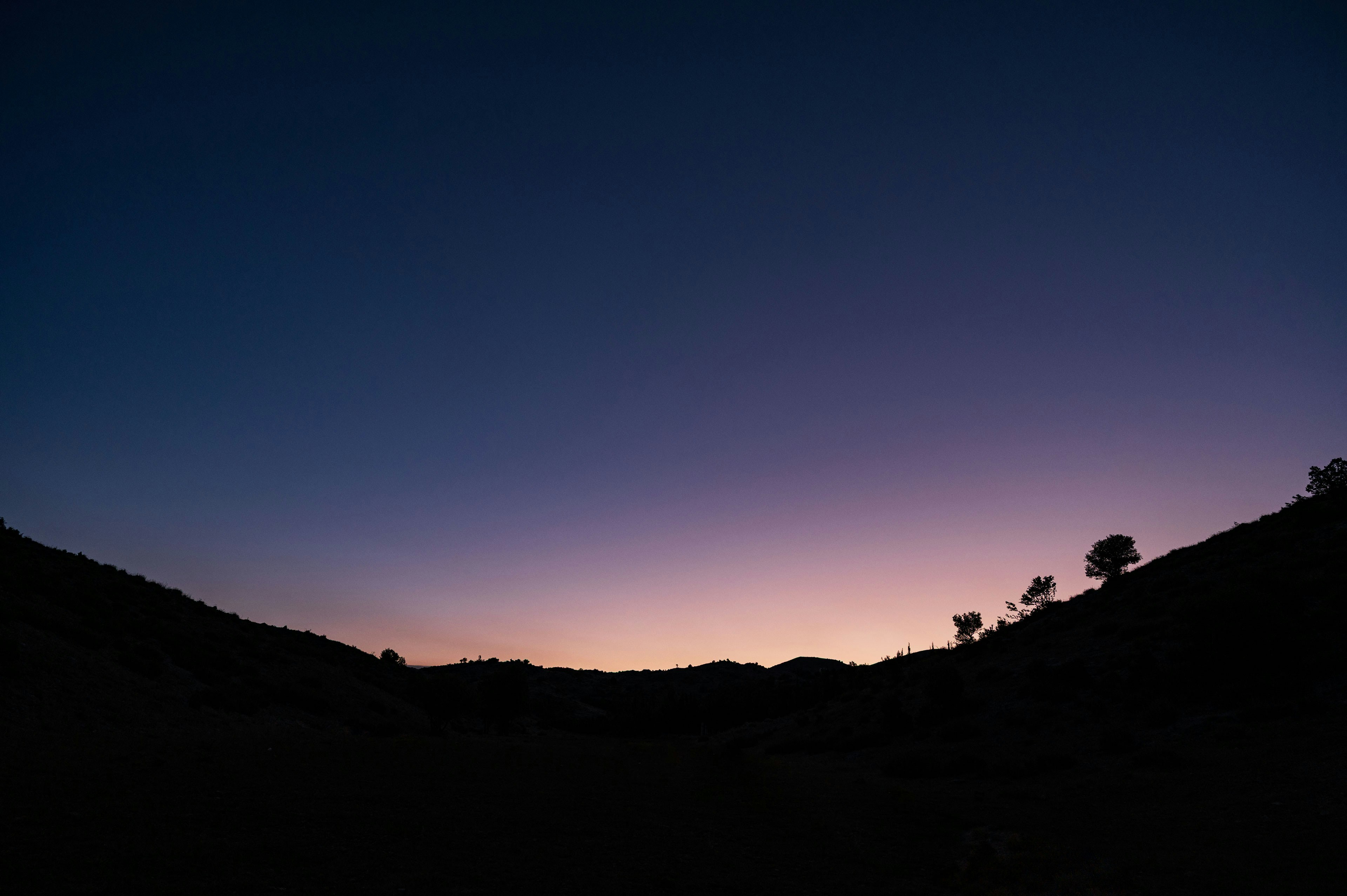 Silhouette of hills against a twilight sky