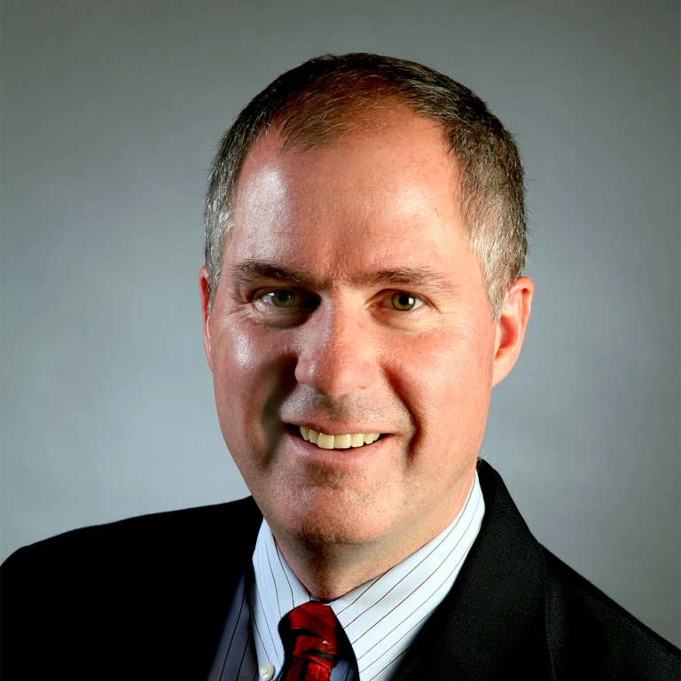 headshot of man in tie