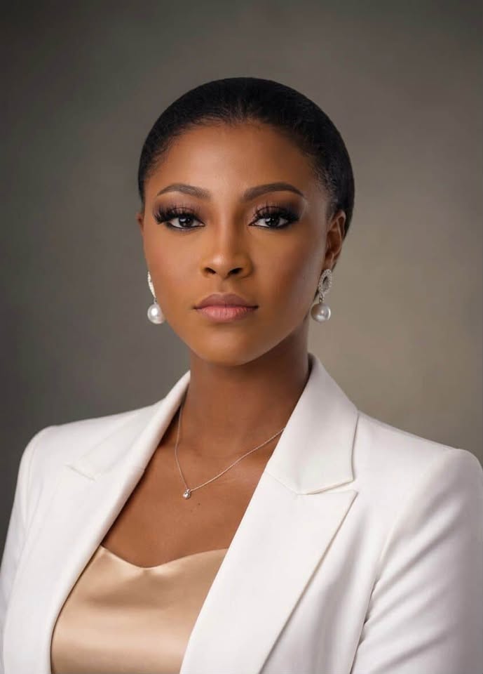 smiling woman sitting on grass during daytime