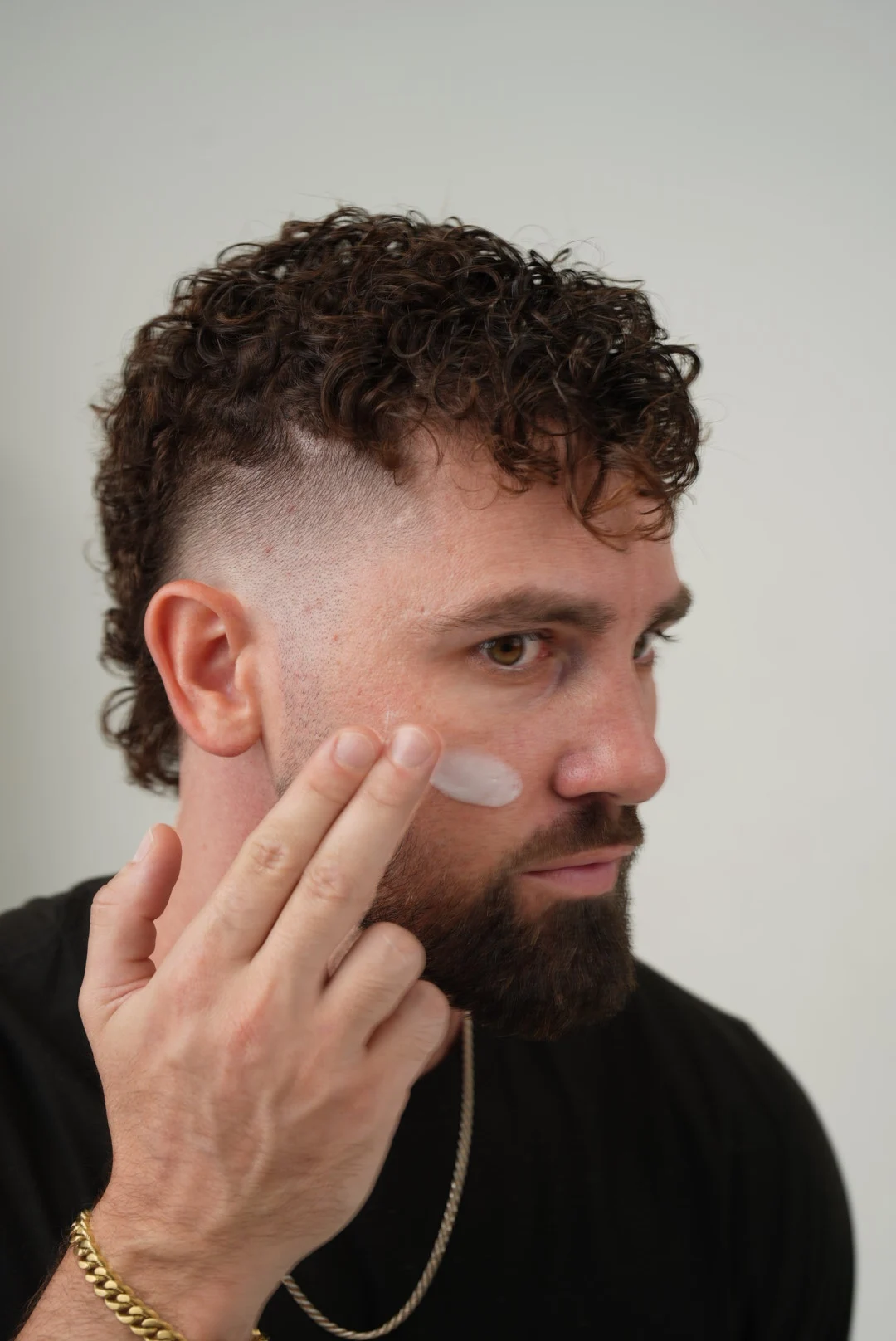 Man applying gentle facial cleanser to remove buildup and impurities for smoother, refreshed skin.