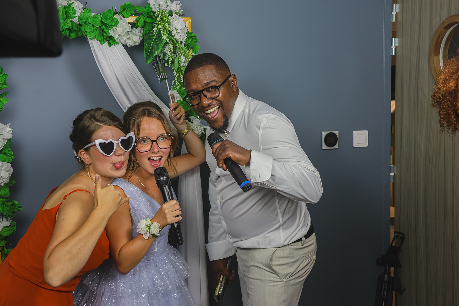 A blank white card resting on a softly draped rust-colored fabric atop a beige quilted surface.