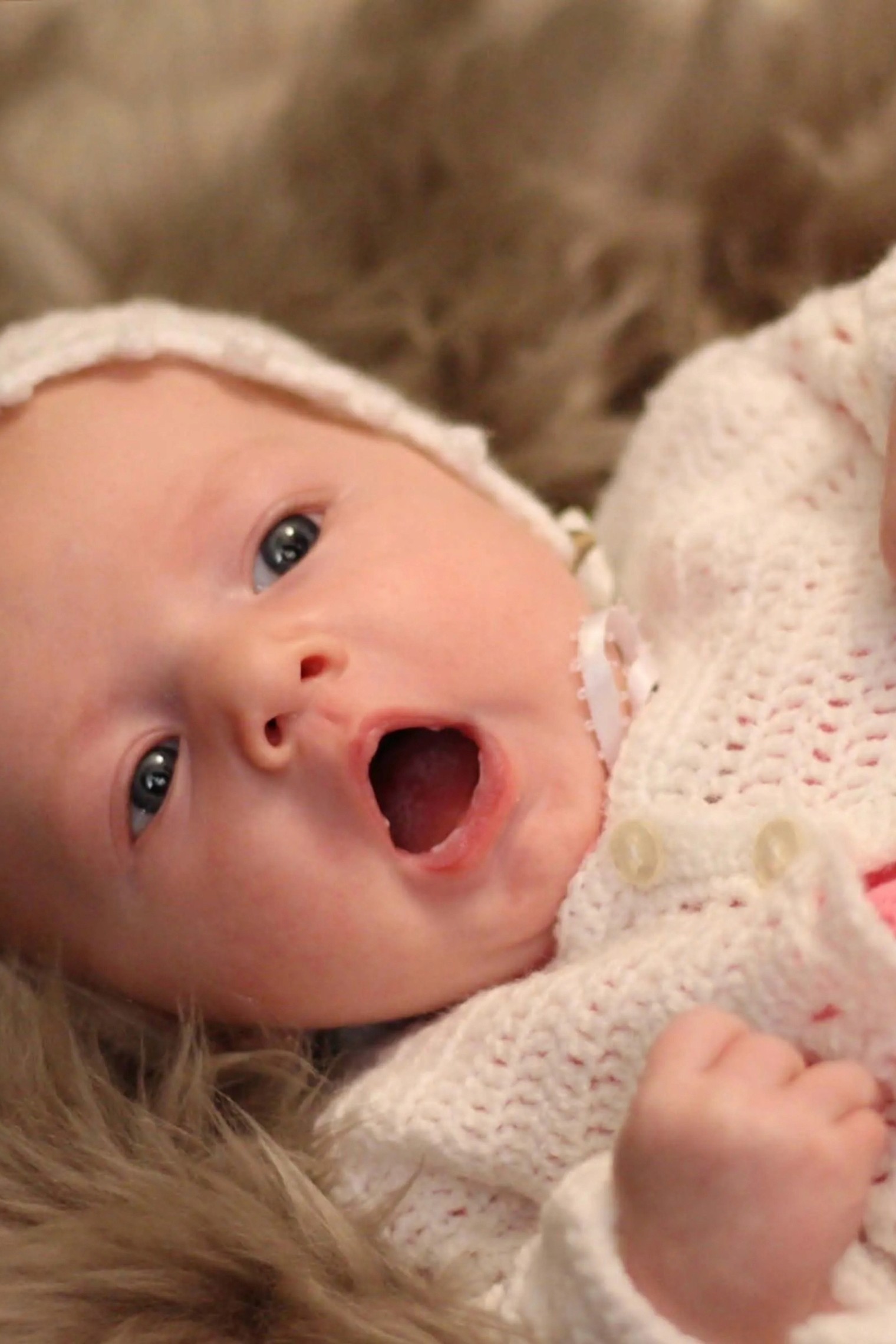 A bride in a lace wedding dress gently holds.
