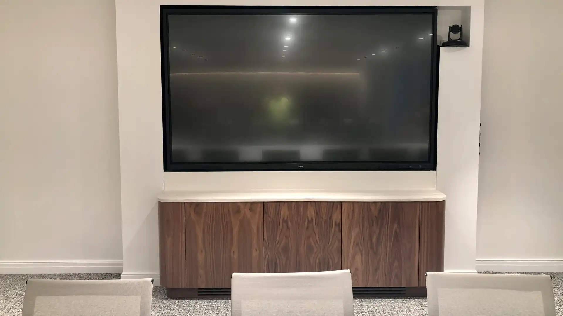Large meeting room display with dedicated video conferencing camera