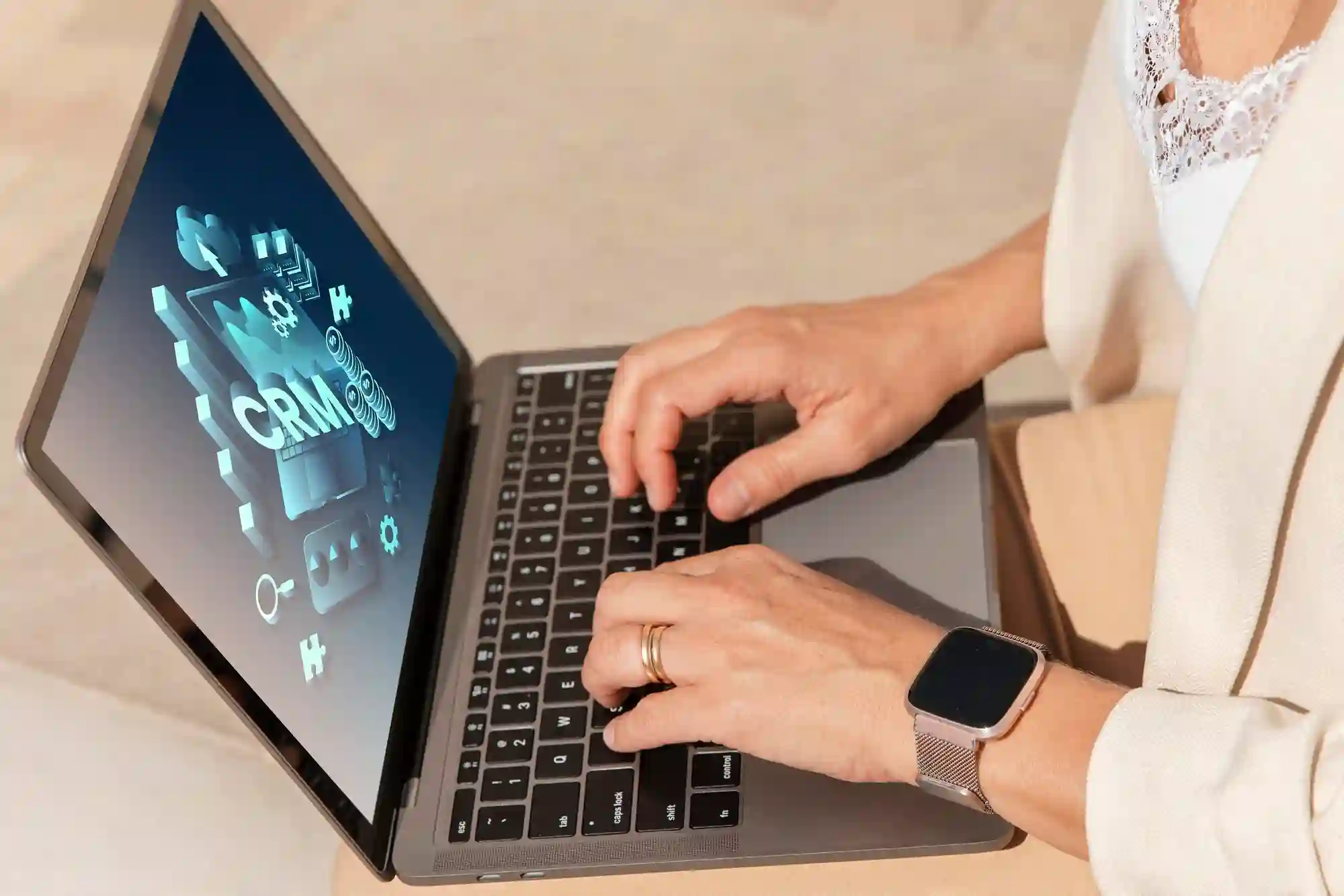 A business professional using a laptop to manage customer relationships through an advanced CRM software interface.