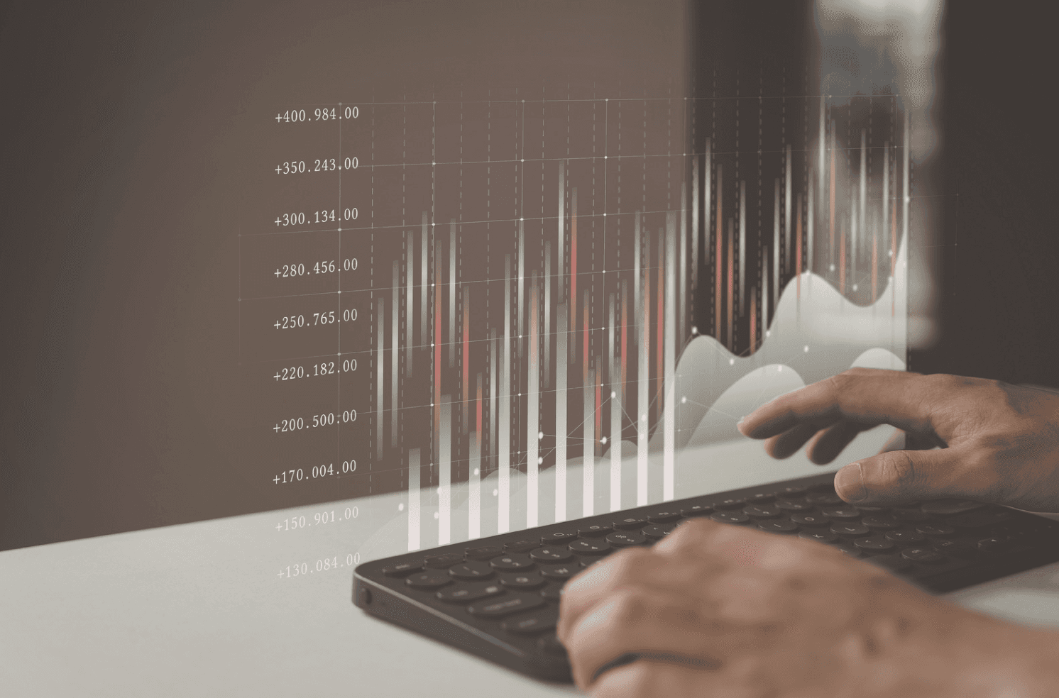 Close-up of hands analyzing digital performance graphs on a laptop, representing tracking trends, search behavior, and campaign signals in Amazon ads.