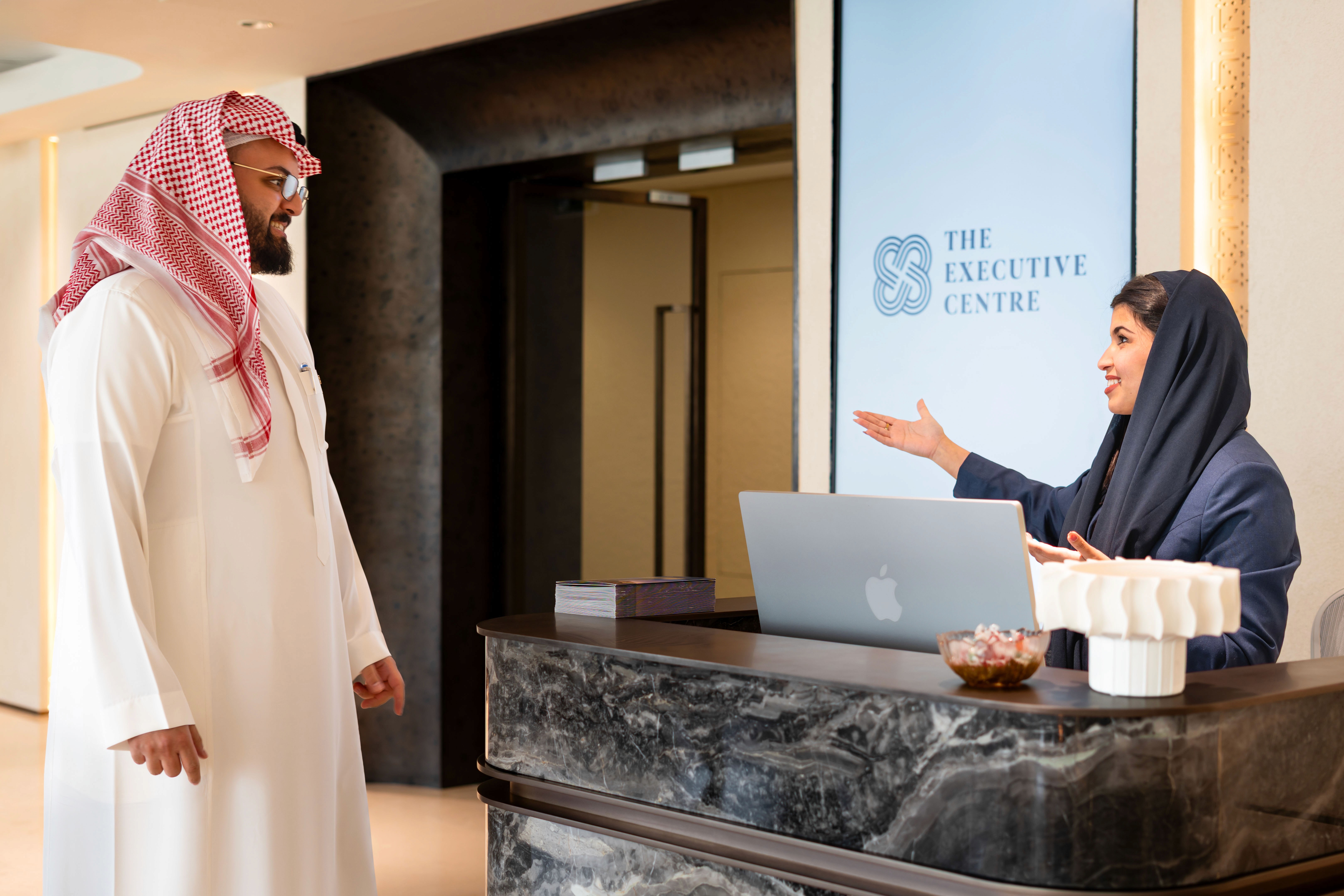 Reception staff at TEC in KAFD, Riyadh welcoming a guest. 