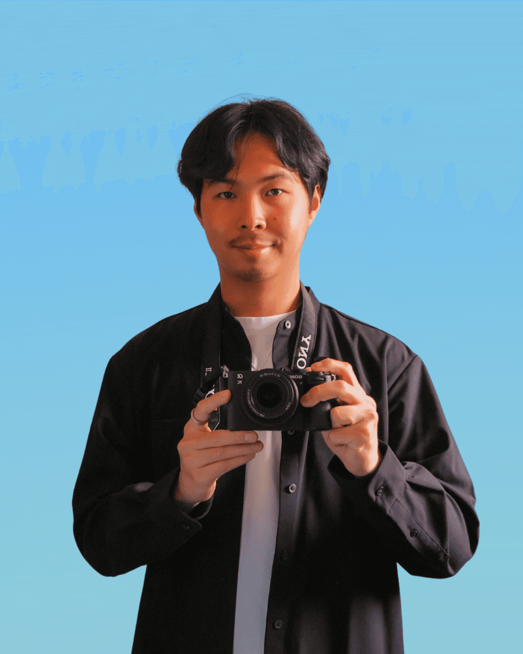 Portrait of a person in a pink sweater against a light background