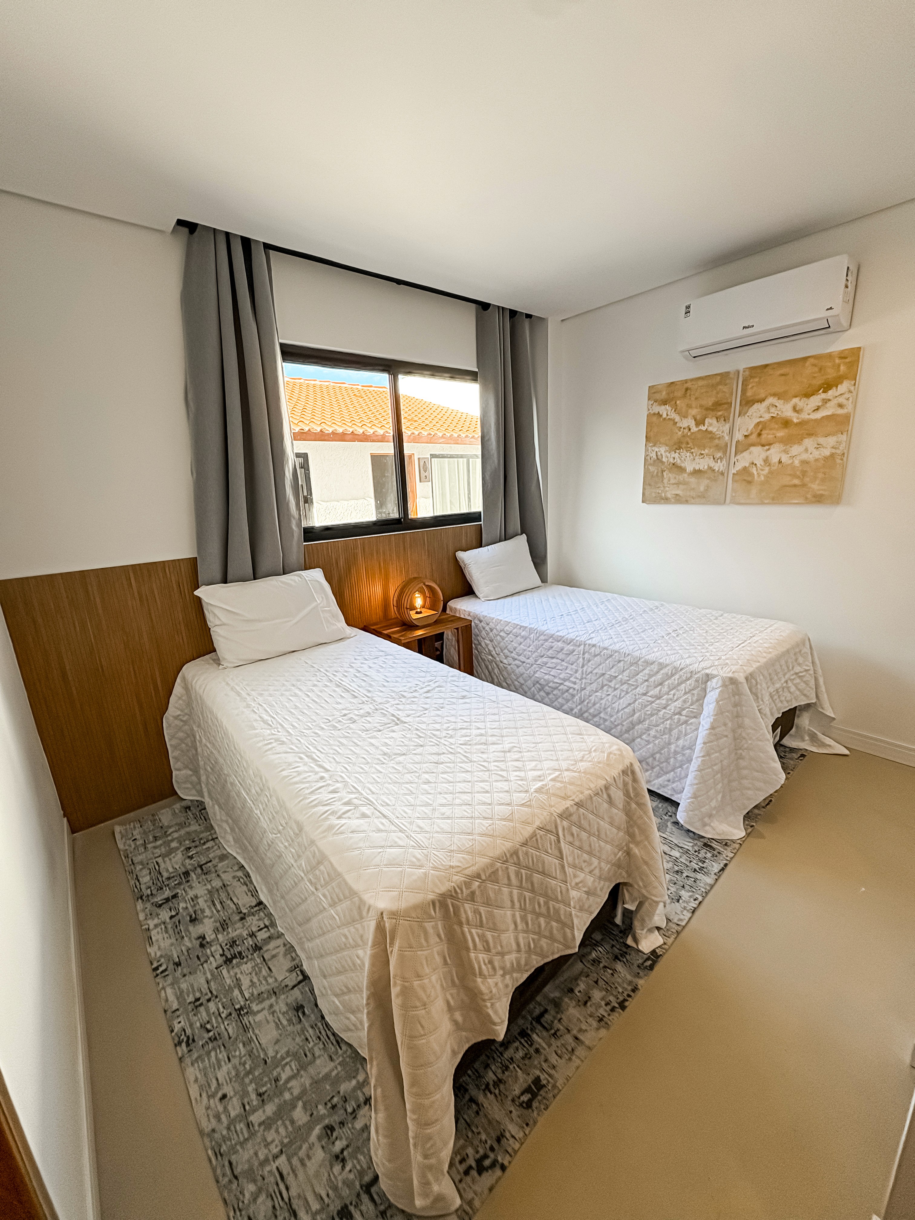 Corner shot from the kitchenette, capturing the compact dining area, sofa, and bed area in one flowing layout.