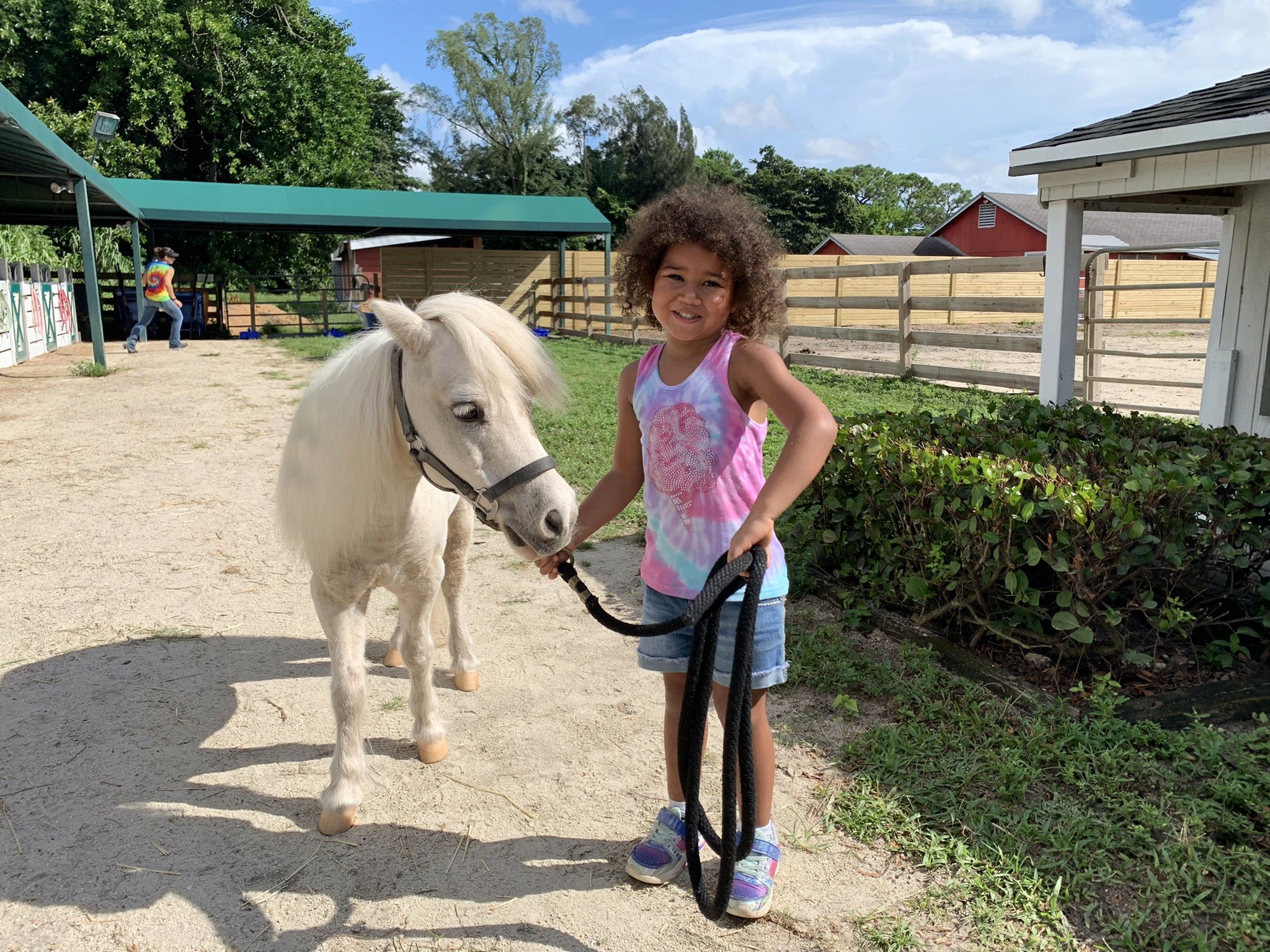 Young dark skinned girl with mini horse while receiving free grief support