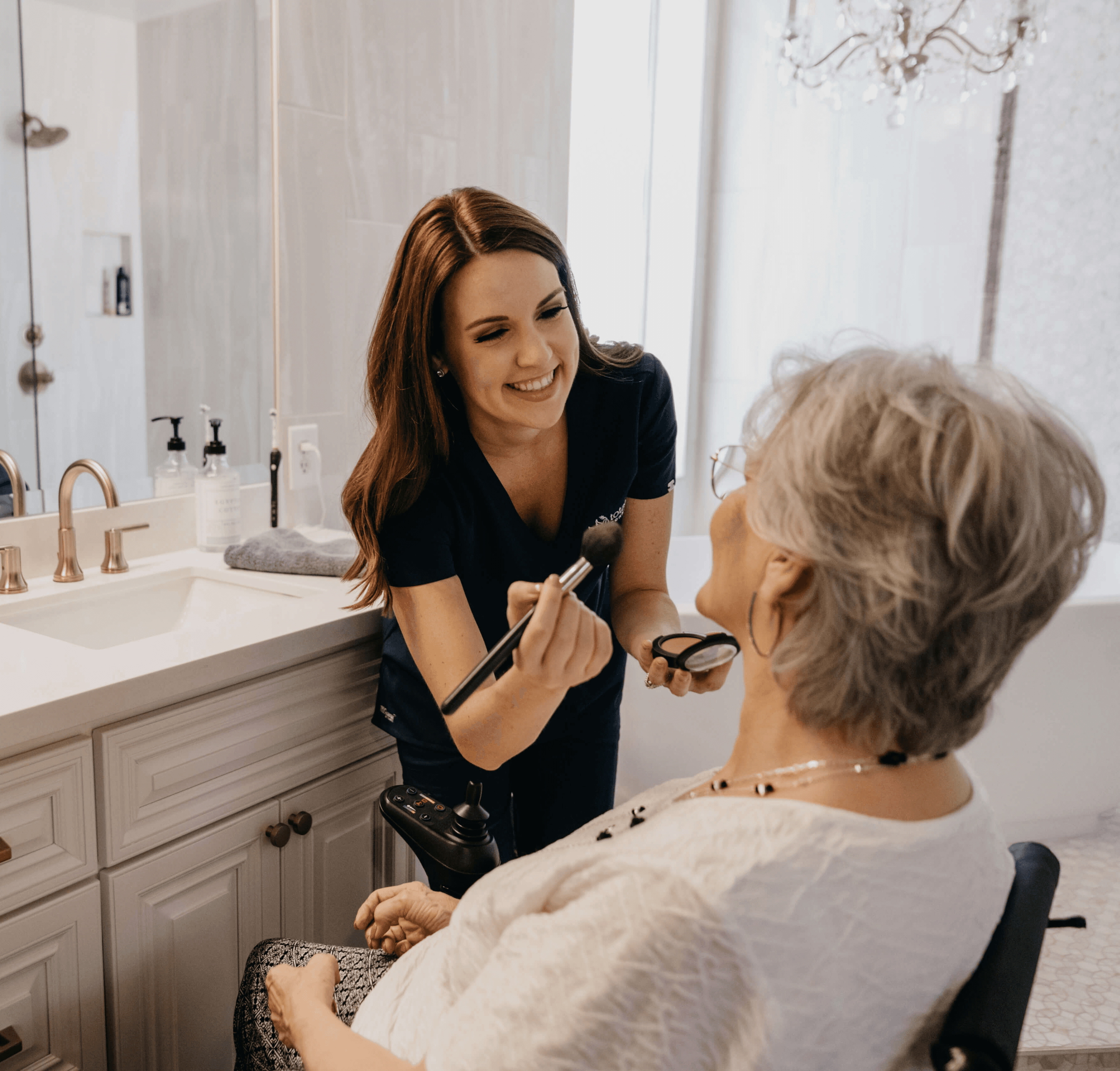 Woman applying face mask to another woman.