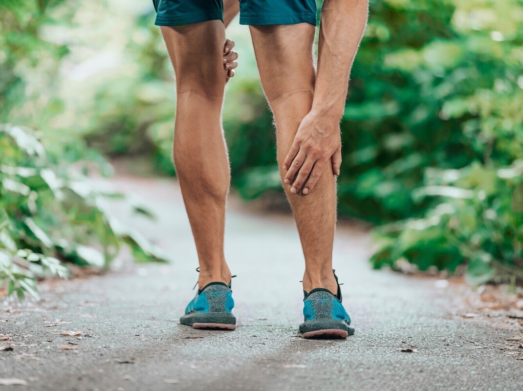 man in fitness gear standing outside with leg pain after walking a mile a day weight loss too often