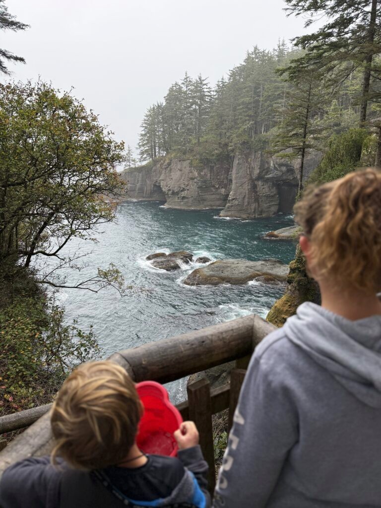 Kids looking out over the cliffs at Cape Flattery from the viewing platform