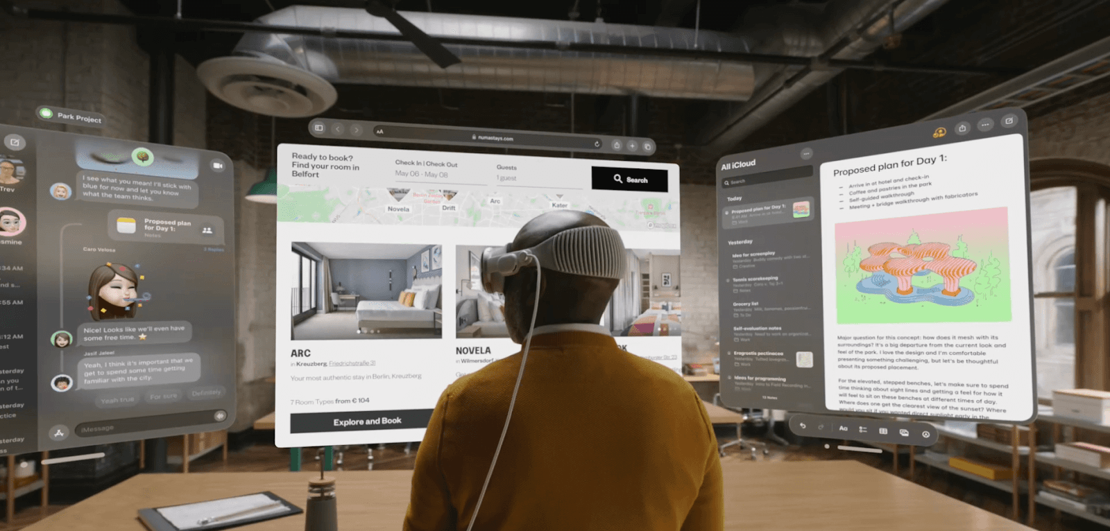 Man using the Vision Pro VR headset with multiple virtual screens displayed in front of him.&nbsp;