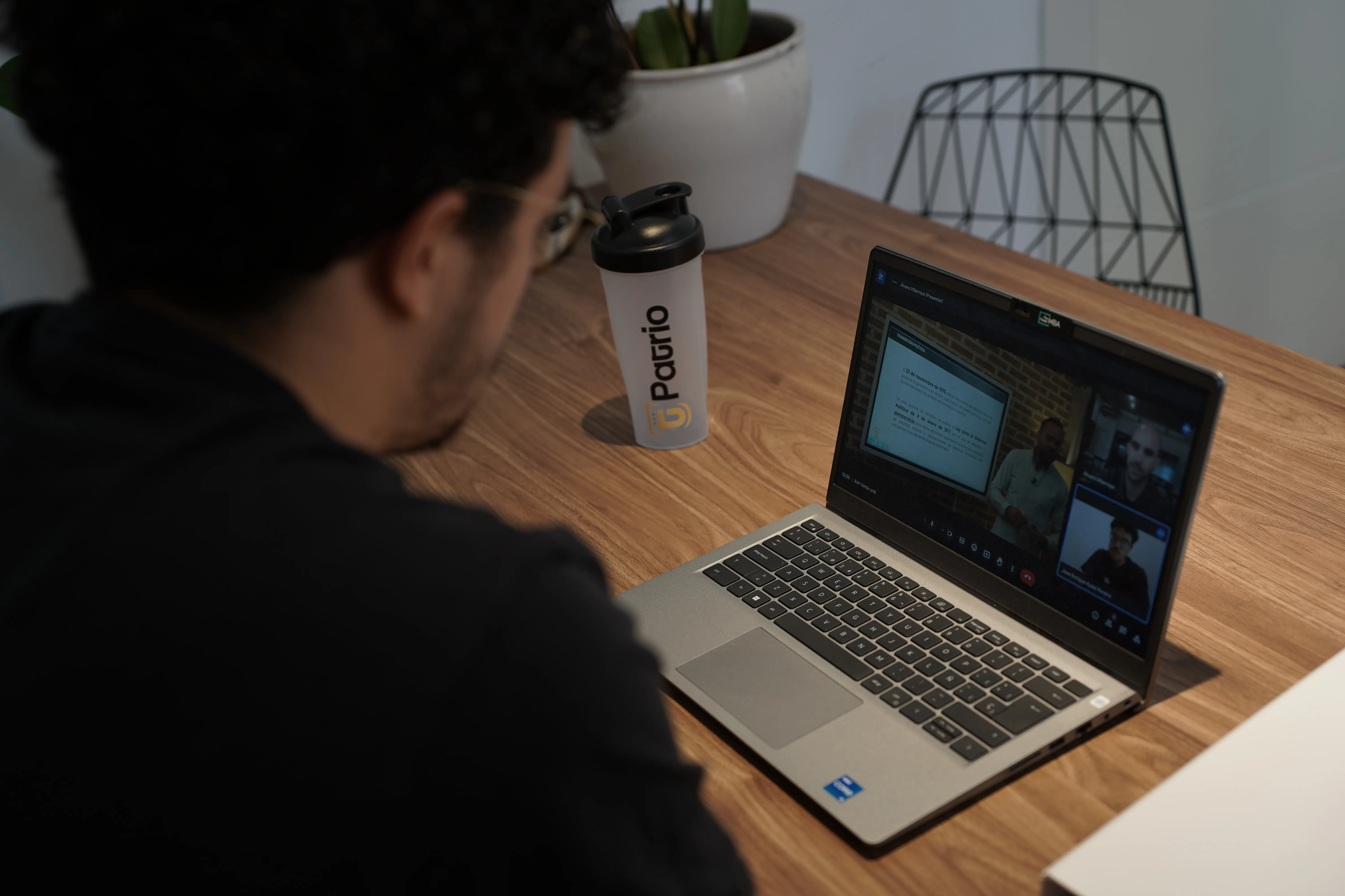 Modern house exterior with a pool and outdoor dining area.