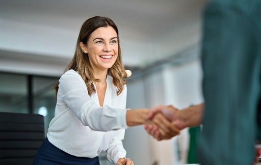 Closeup of business handshake symbolizing partnership, trust, and onboarding with EU compliance experts.