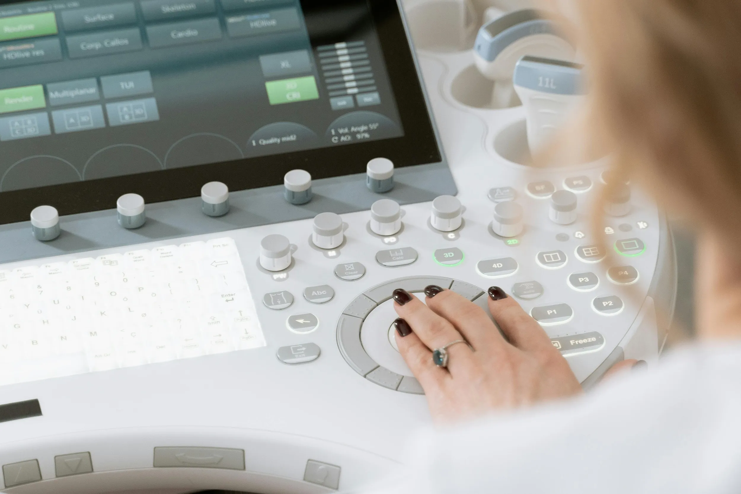 Healthcare professional operating ultrasound machine control panel, medical imaging workflow