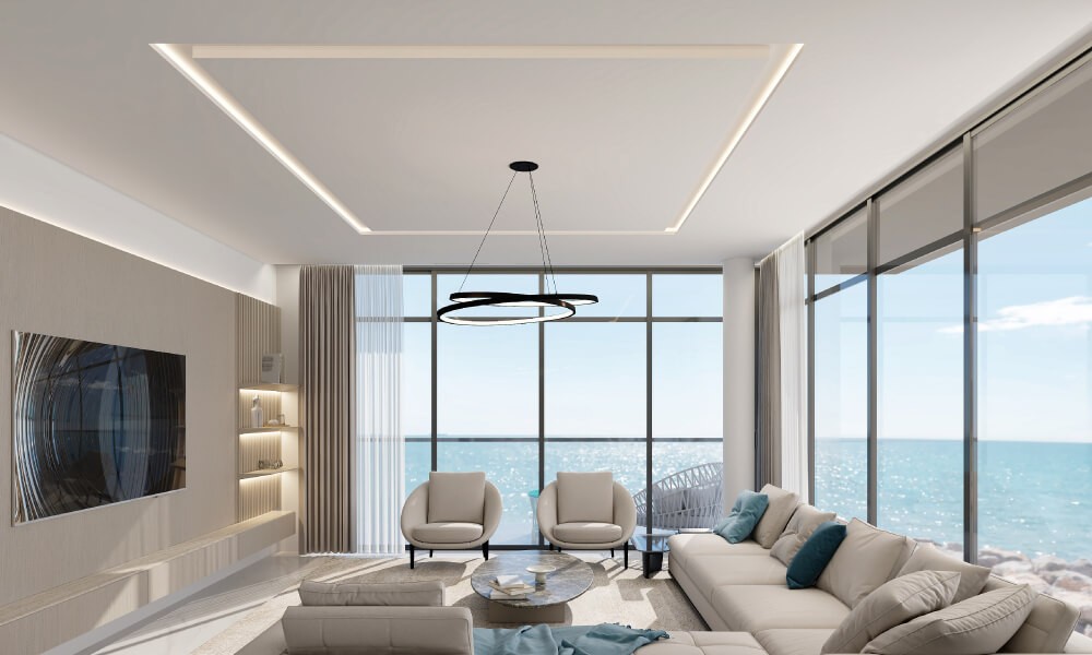 Stylish living room with a plush couch and dining area, exemplifying ARIA by Beyond's modern design.