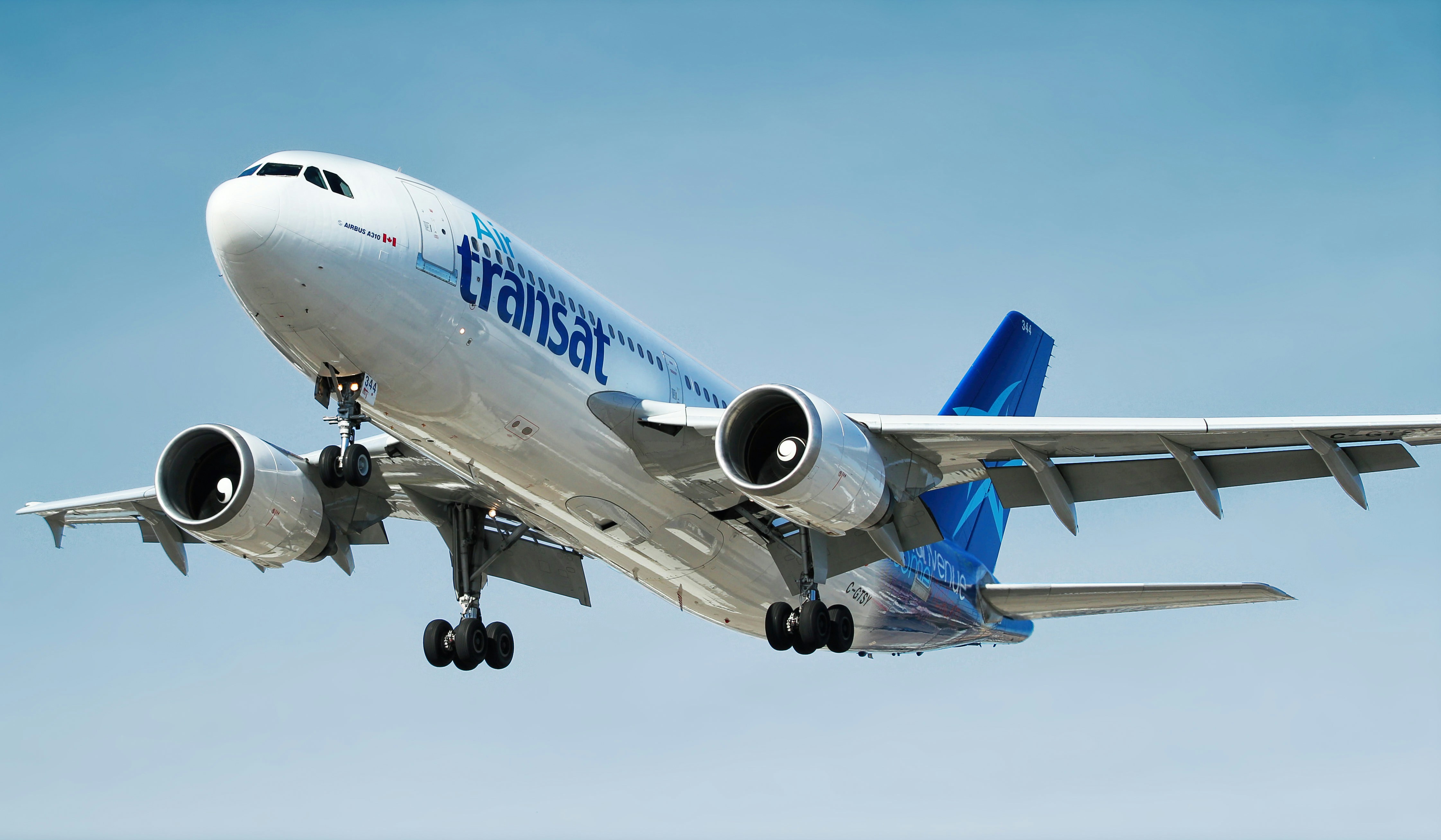 An Air Transat plane flying in the air.